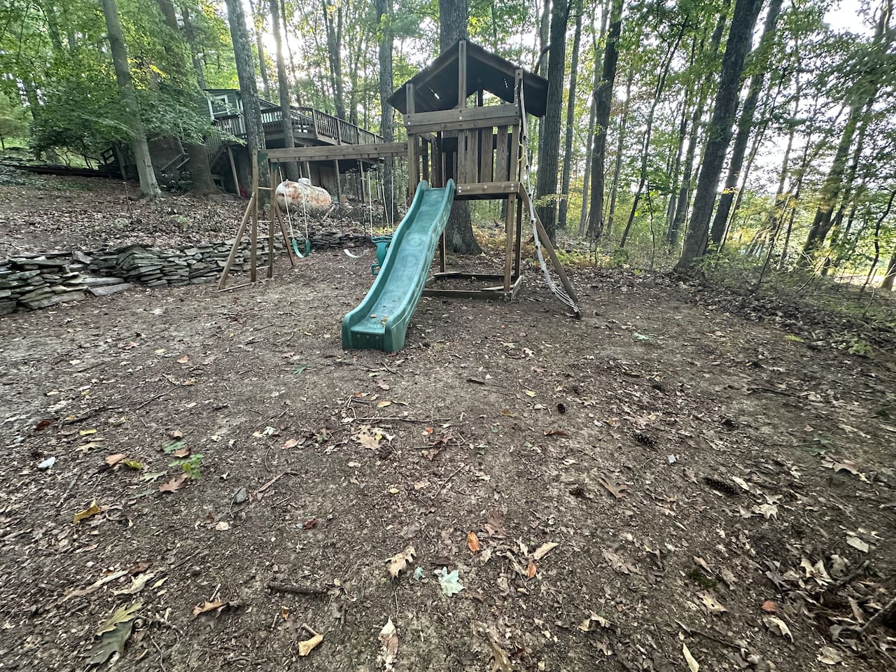 Nestled among mature trees, the property offers a peaceful woodland vibe plus a charming children’s play area—ideal for families to relax while the kids explore and enjoy nature.