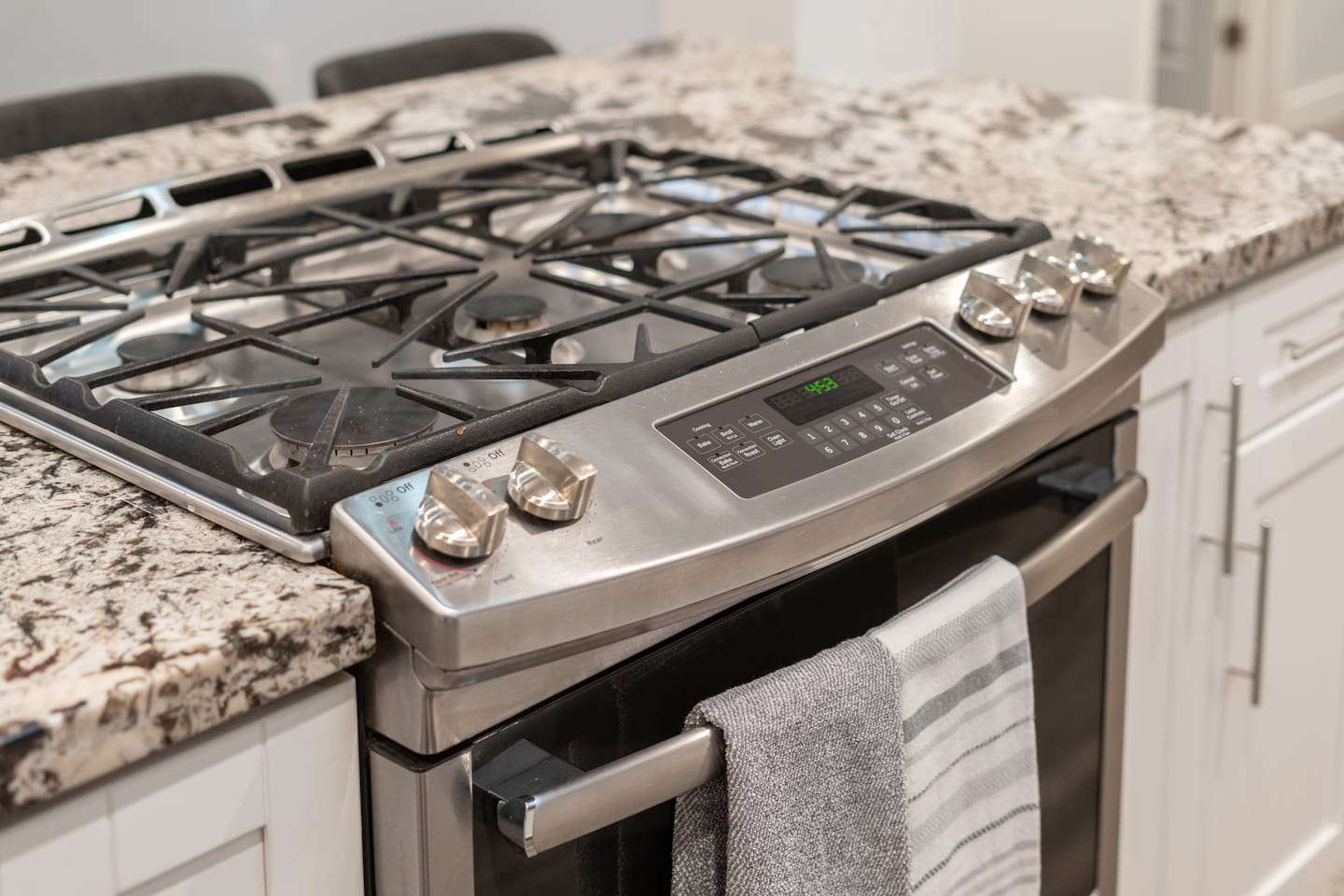Stainless steel gas stove with built-in oven, featuring a sleek design and modern functionality for all your cooking needs.