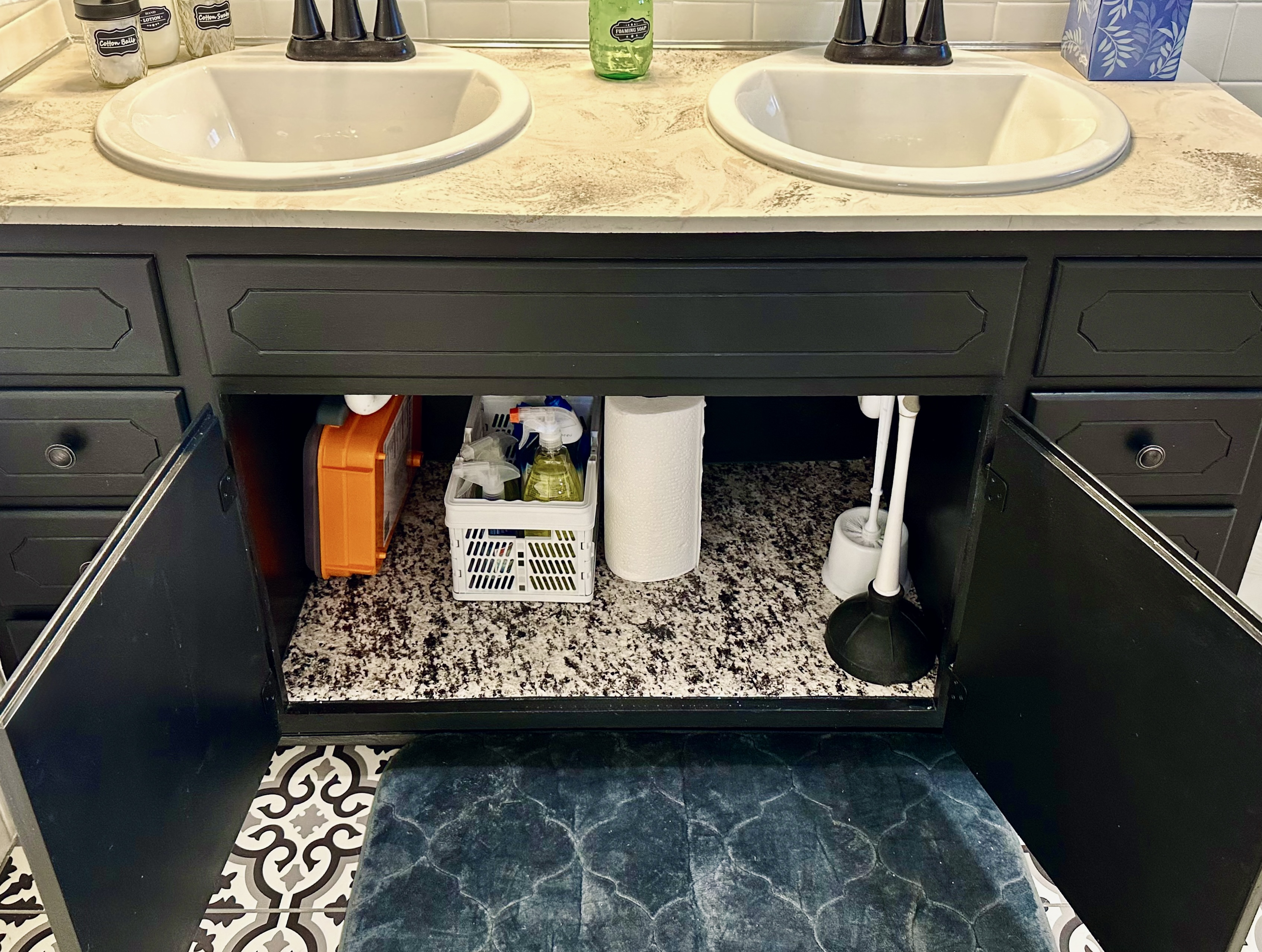 Main bathroom cabinet stocked with practical essentials, including a large first aid kit and bathroom-specific cleaning products. Everything is neatly organized and easy to find, giving guests peace of mind for both everyday needs and minor emergencies.