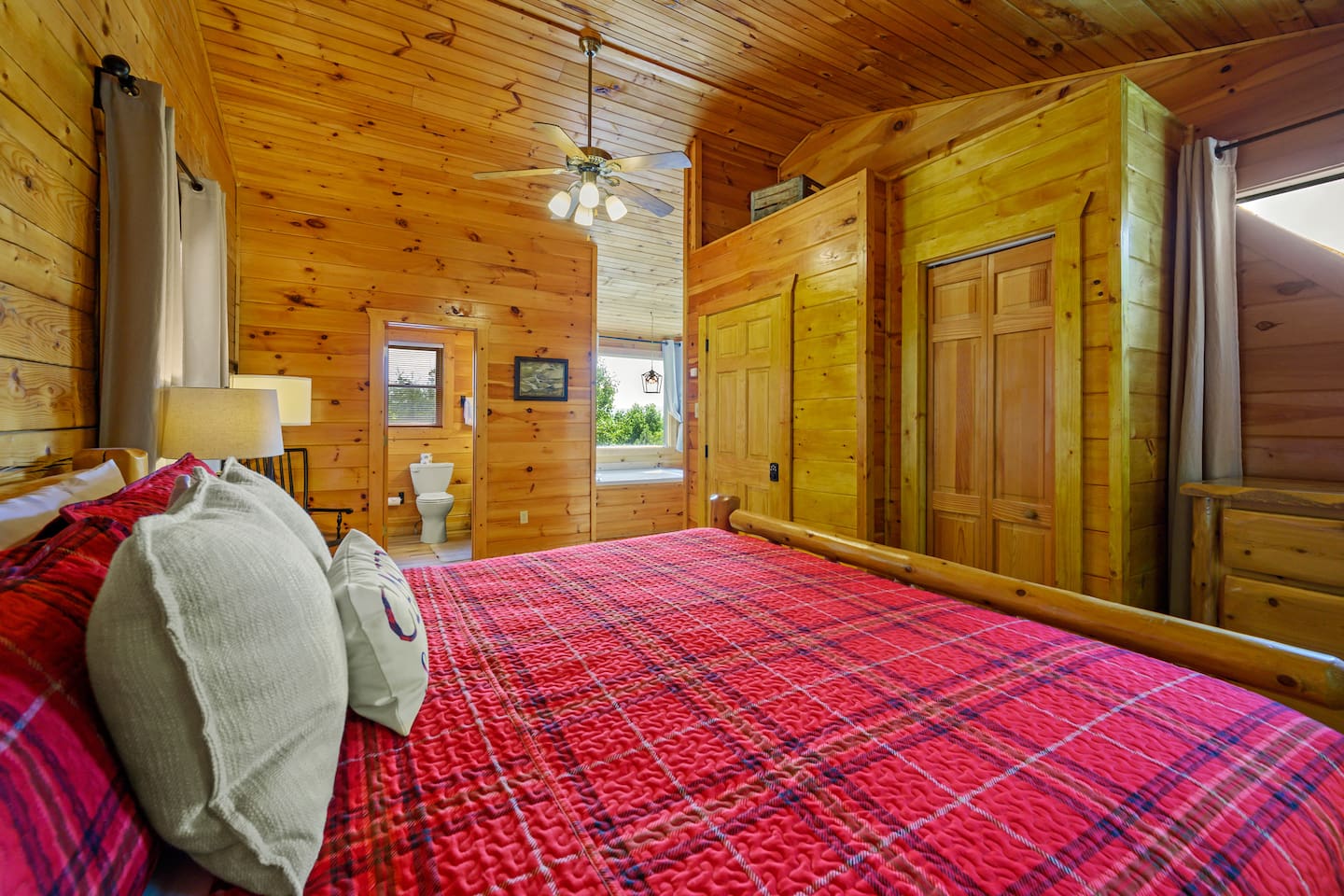 The top floor bedroom has a king bed, 43" smart TV, closet, dresser, 2 person jacuzzi tub, and ensuite full bathroom. 