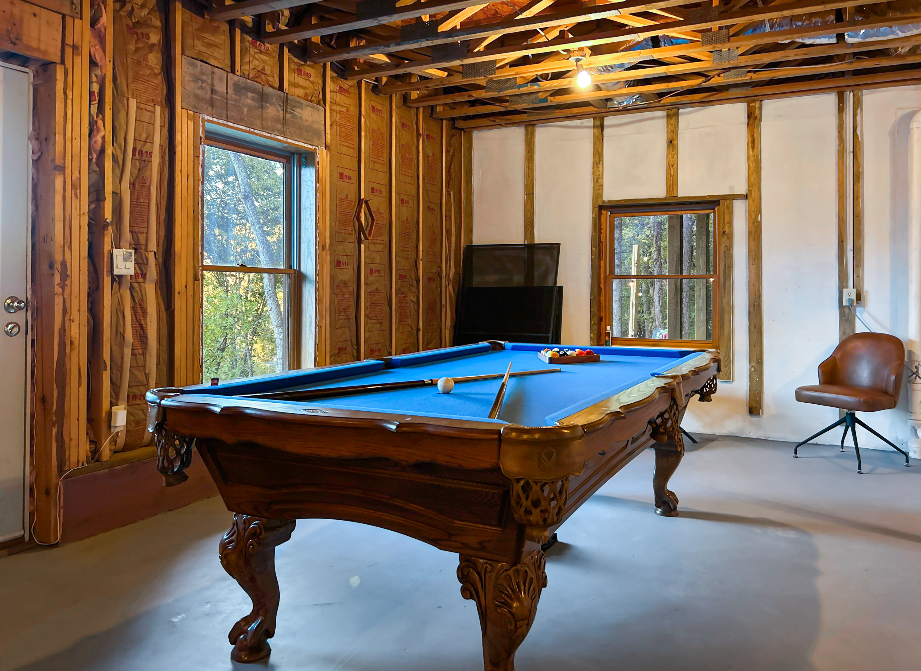 The basement has a game room with a pool table and ping pong table