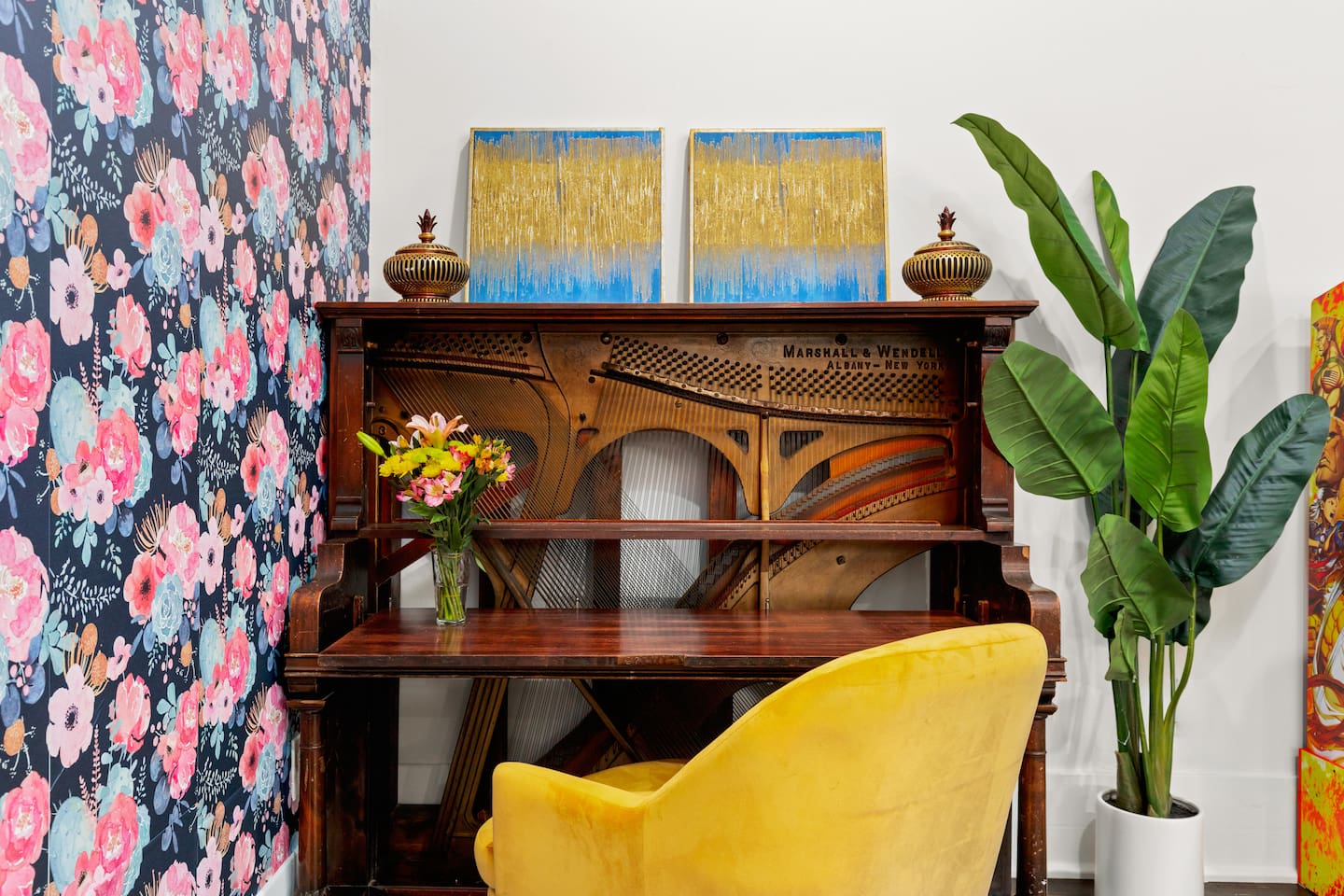 Find inspiration at our inventive workspace, a cleverly repurposed piano desk set against a blooming backdrop, perfect for sparking creativity during your stay.