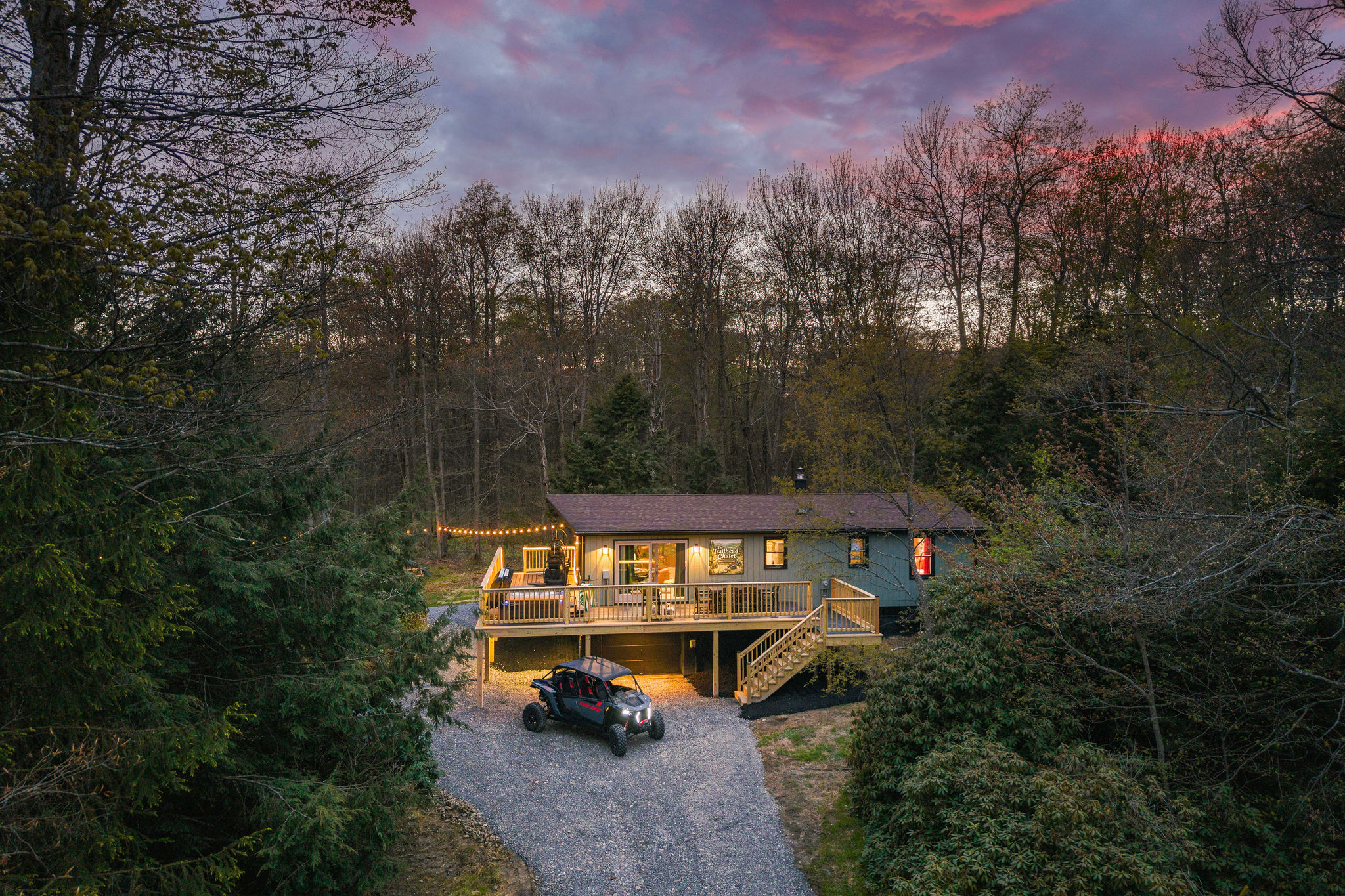 🚙 Home base in the woods, vehicles tucked in for the night.