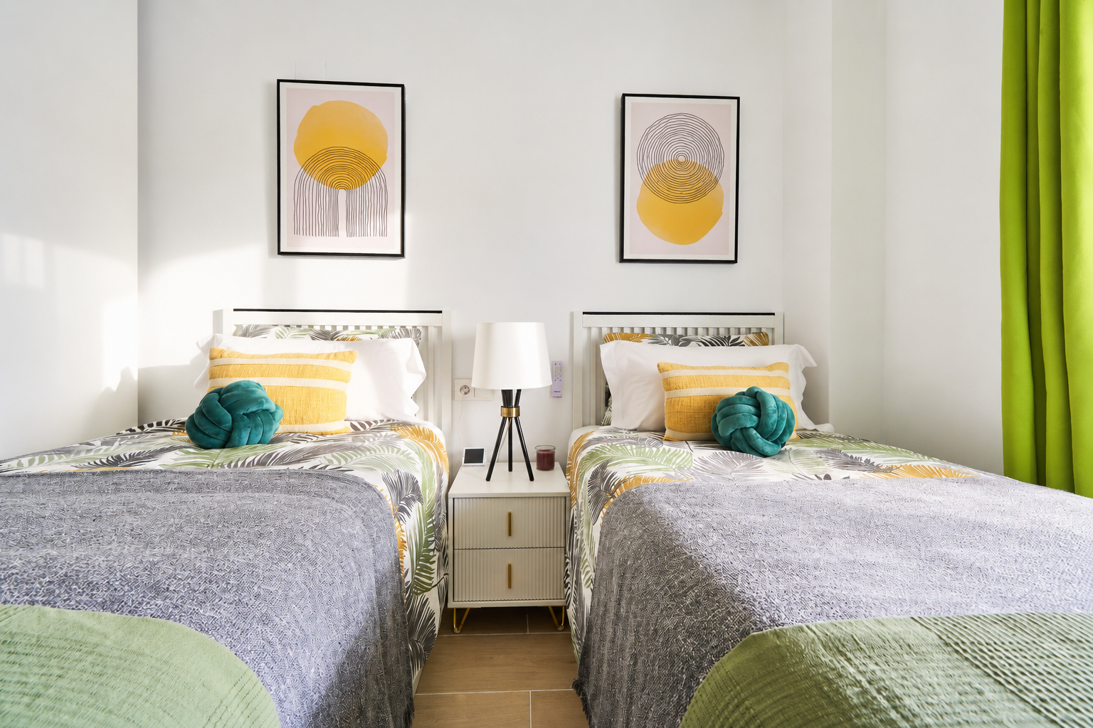Bright and calming twin bedroom with tropical tones, soft linens, and direct access to the terrace - perfect for relaxed mornings and restful nights.