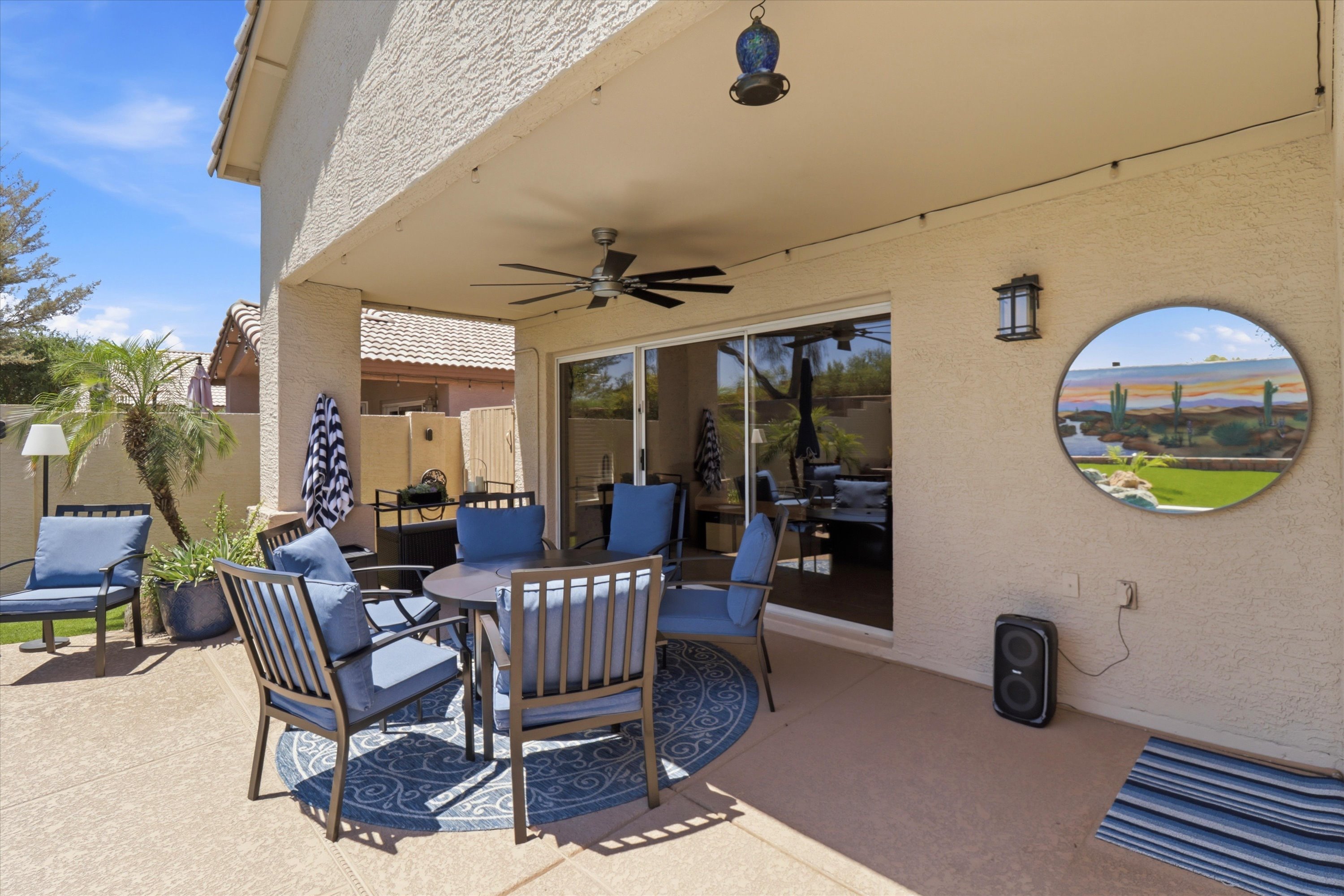 Covered patio seating with pool views, ceiling fan, and shaded space for outdoor meals or relaxed downtime.
