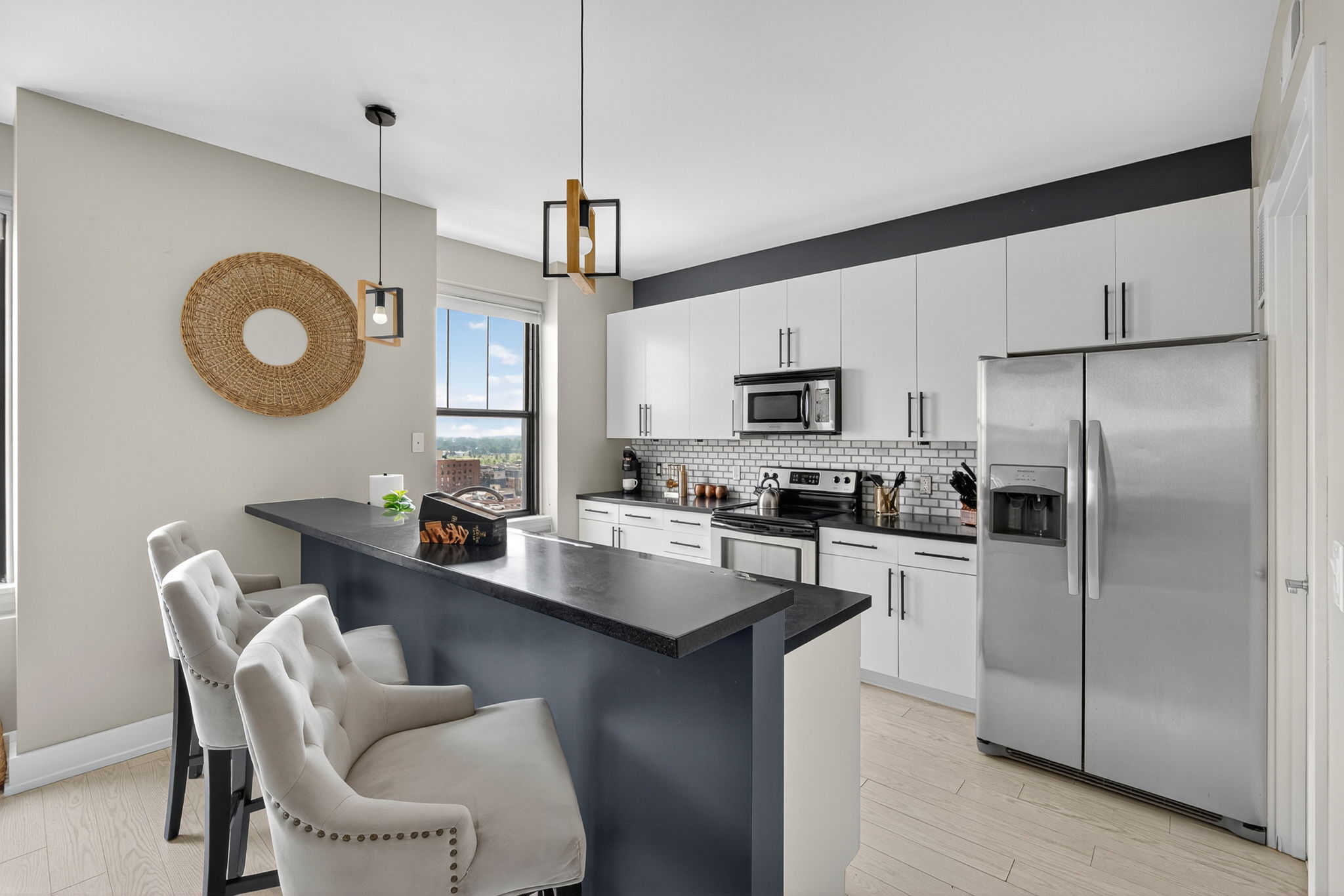 Sleek and functional kitchen island featuring a double sink, modern fixtures, and a view into the open-concept living space.