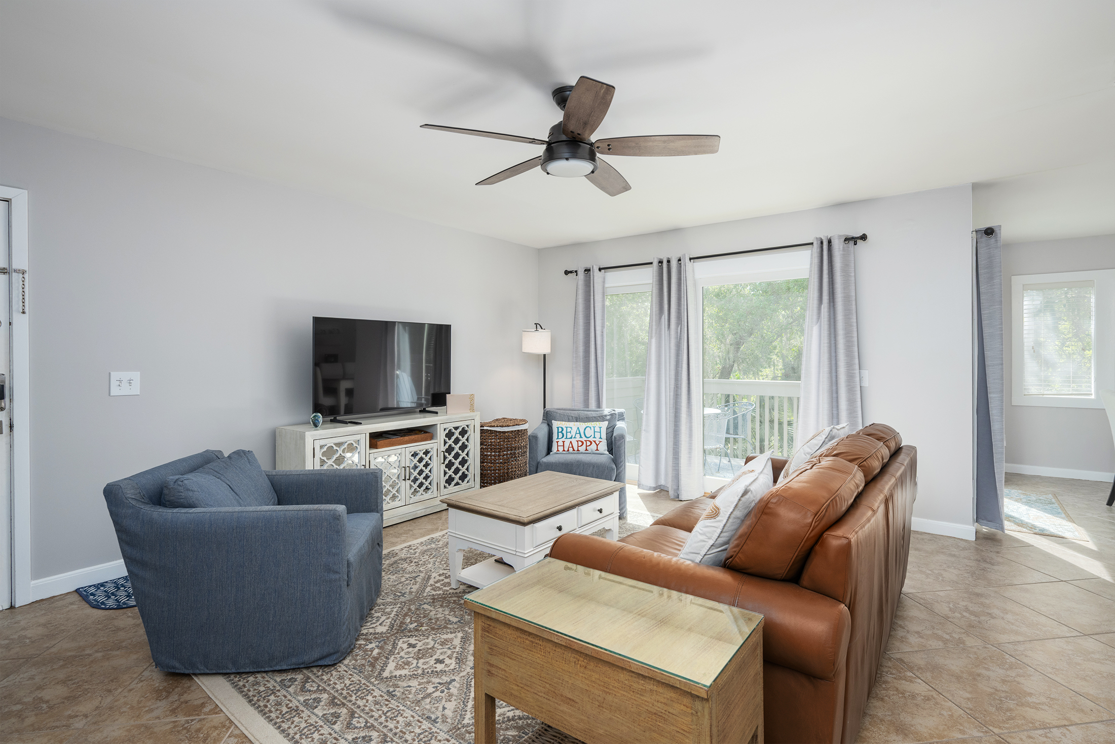 Living room features a 55" LED HDTV, new couch and chairs