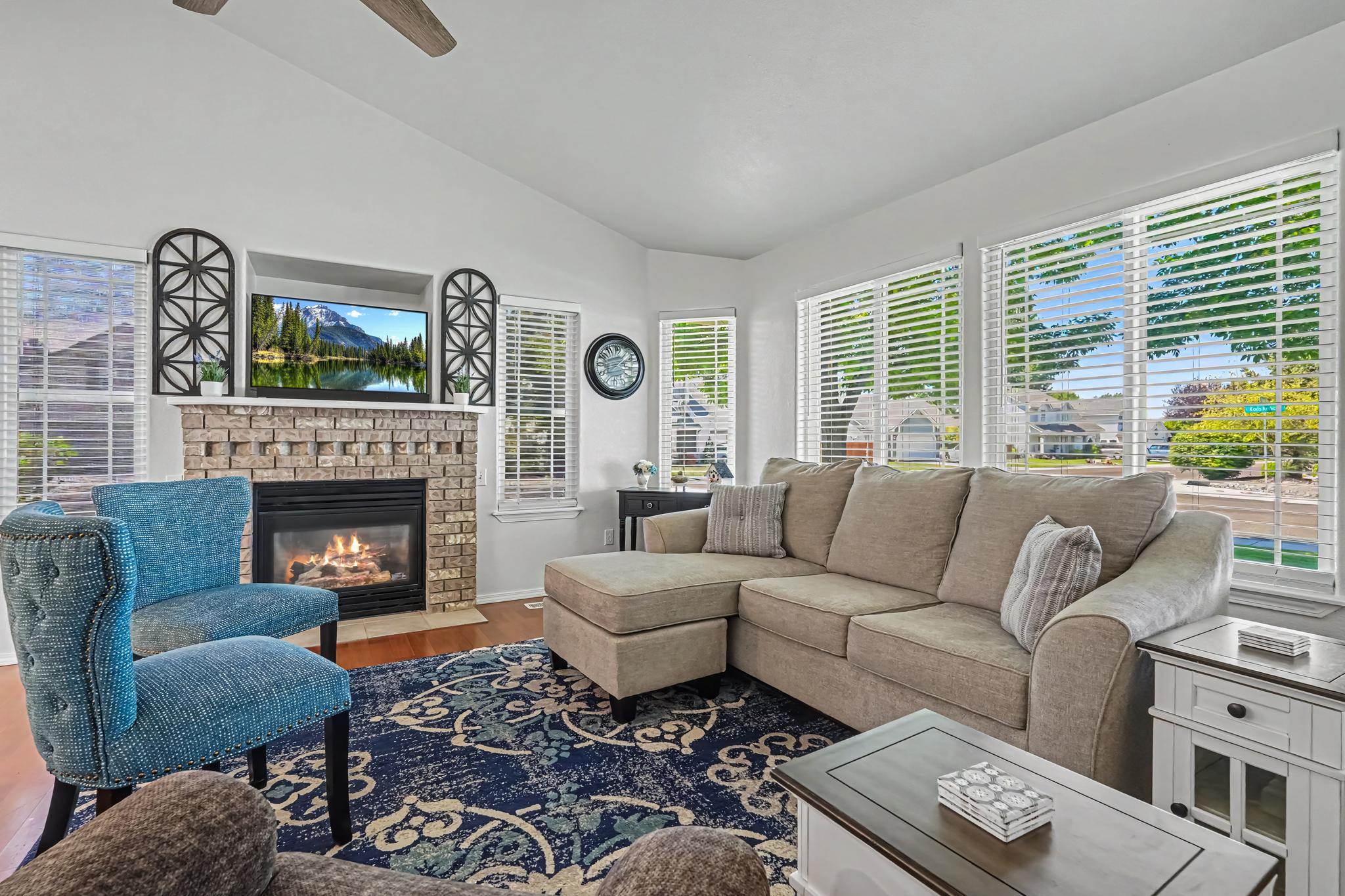 The open living room offers plenty of comfortable seating for everyone. Cozy up by the fireplace in winter or enjoy the spacious layout for games, yoga, or an air mattress for extra guests. It's the perfect gathering space for family and friends.
