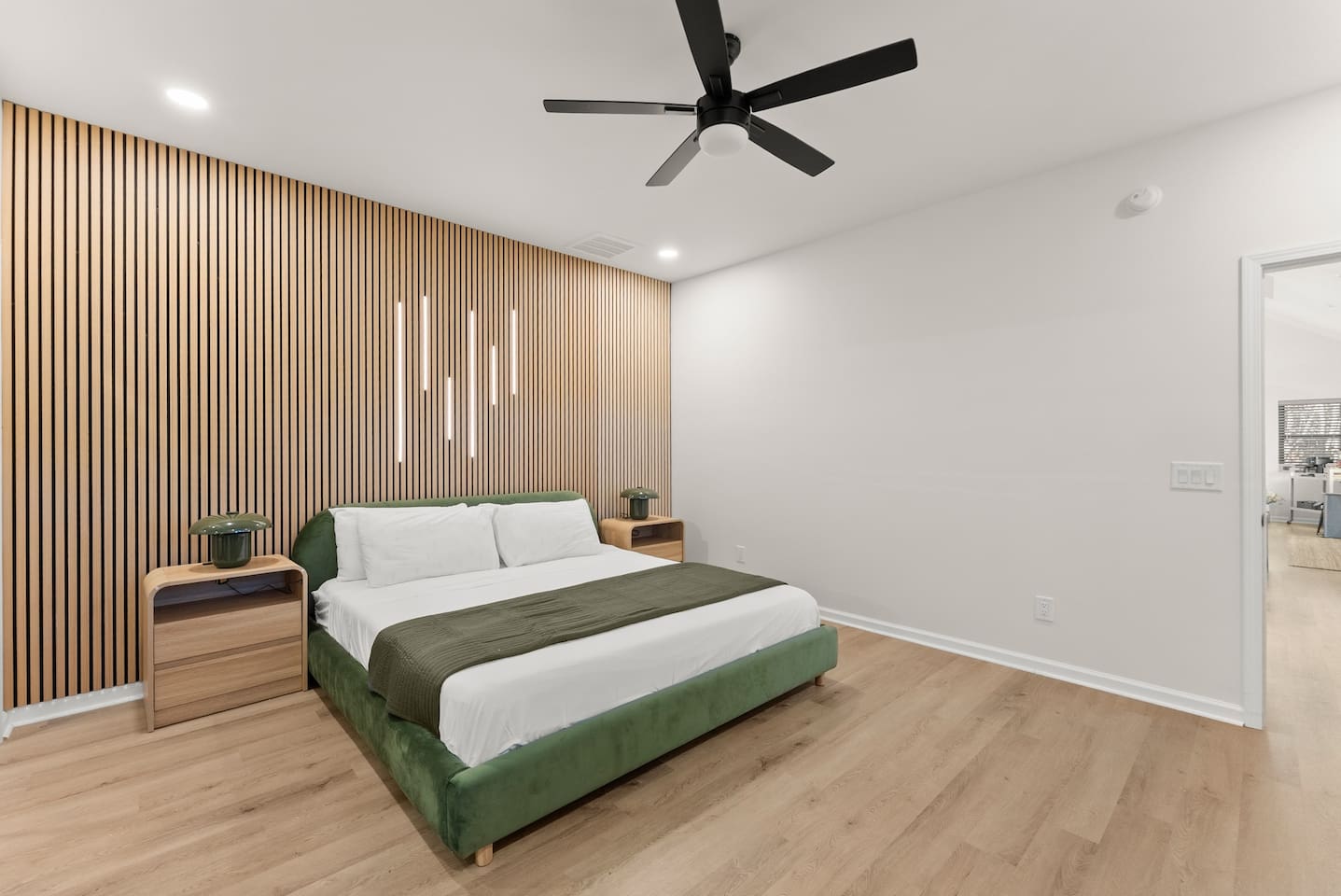 Spacious master bedroom with a king bed, cozy electric fireplace, and a private en-suite bathroom—your perfect retreat.”