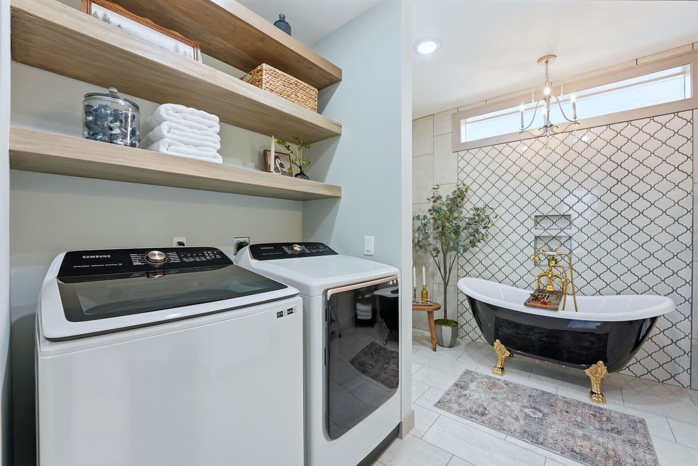 Convenient in-home laundry area with modern washer and dryer, open shelving, and fresh linens—perfect for extended stays and added comfort.
