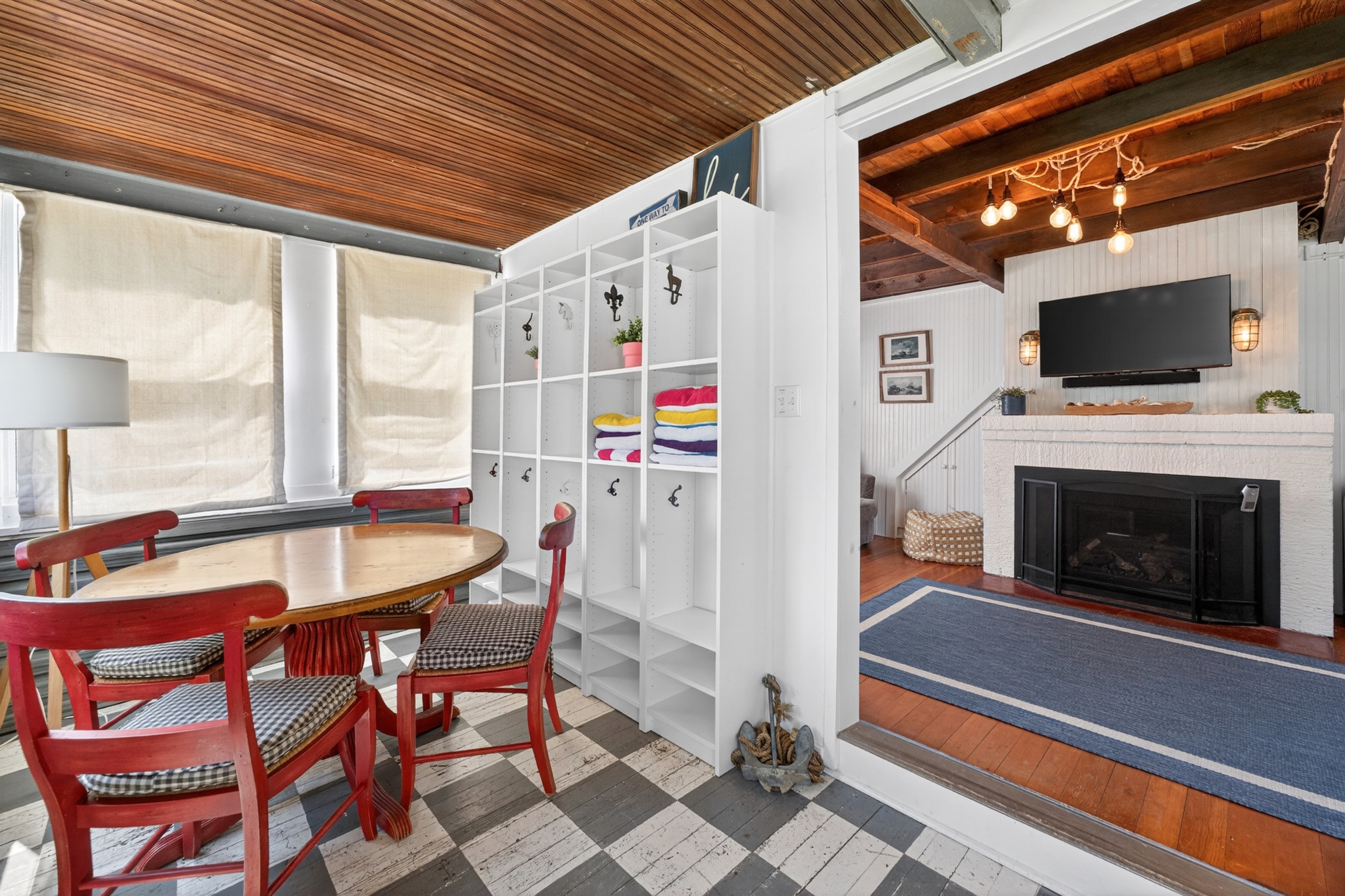 Step into this coastal cottage and you’ll find a welcoming game table and a spacious living room perfect for gathering and relaxing.