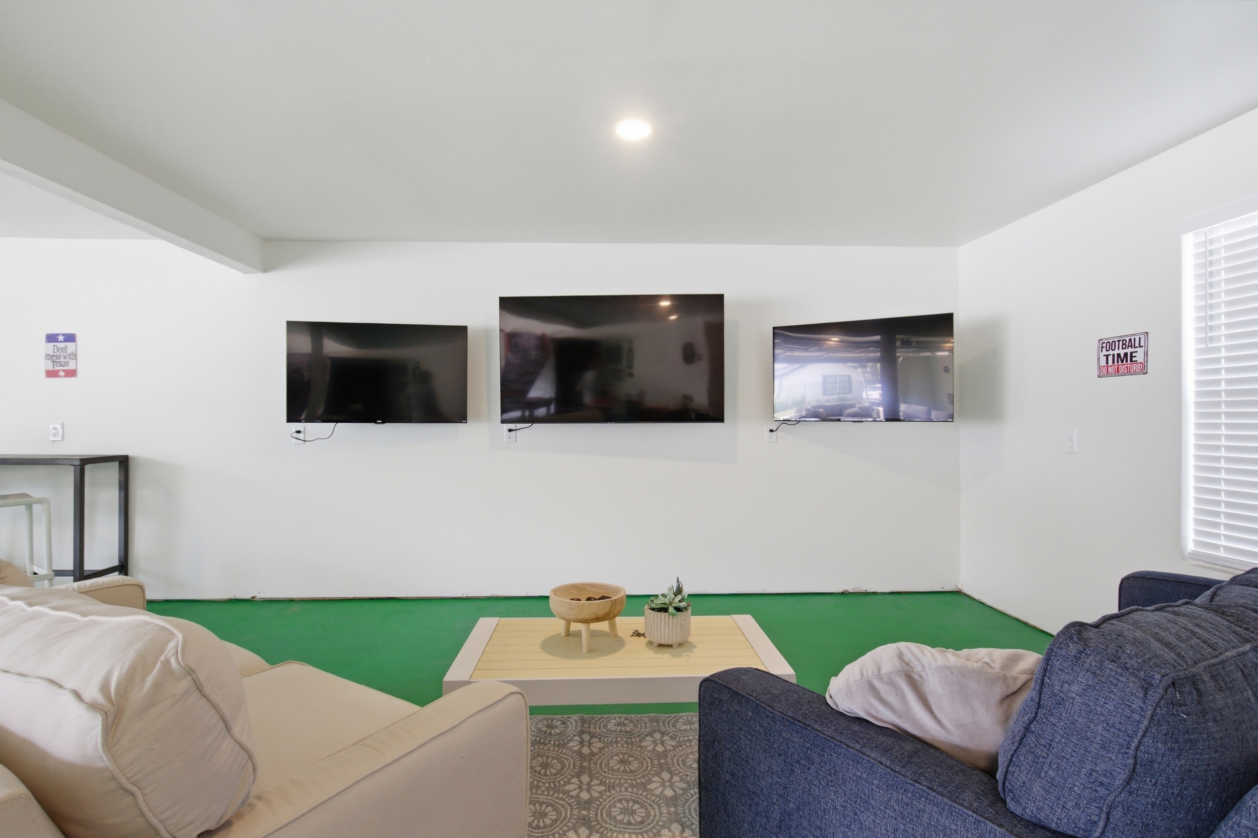 Game Room lounge zone with sectional seating and 60" Smart TV. Watch the Cowboys pregame then walk to the stadium. 1,000 sq ft of entertainment space included.