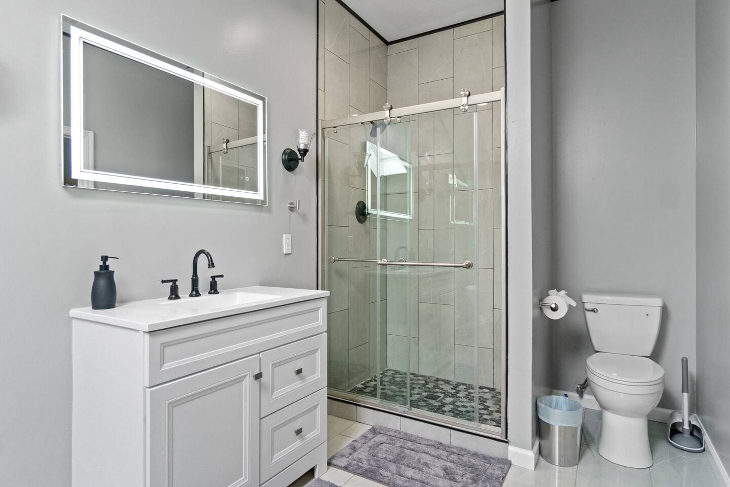 Bathroom with a modern shower and toilet, designed for convenience and functionality in a clean, compact space.