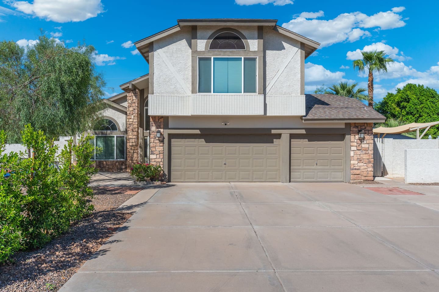 A striking two-story facade with timeless stone and stucco detailing.