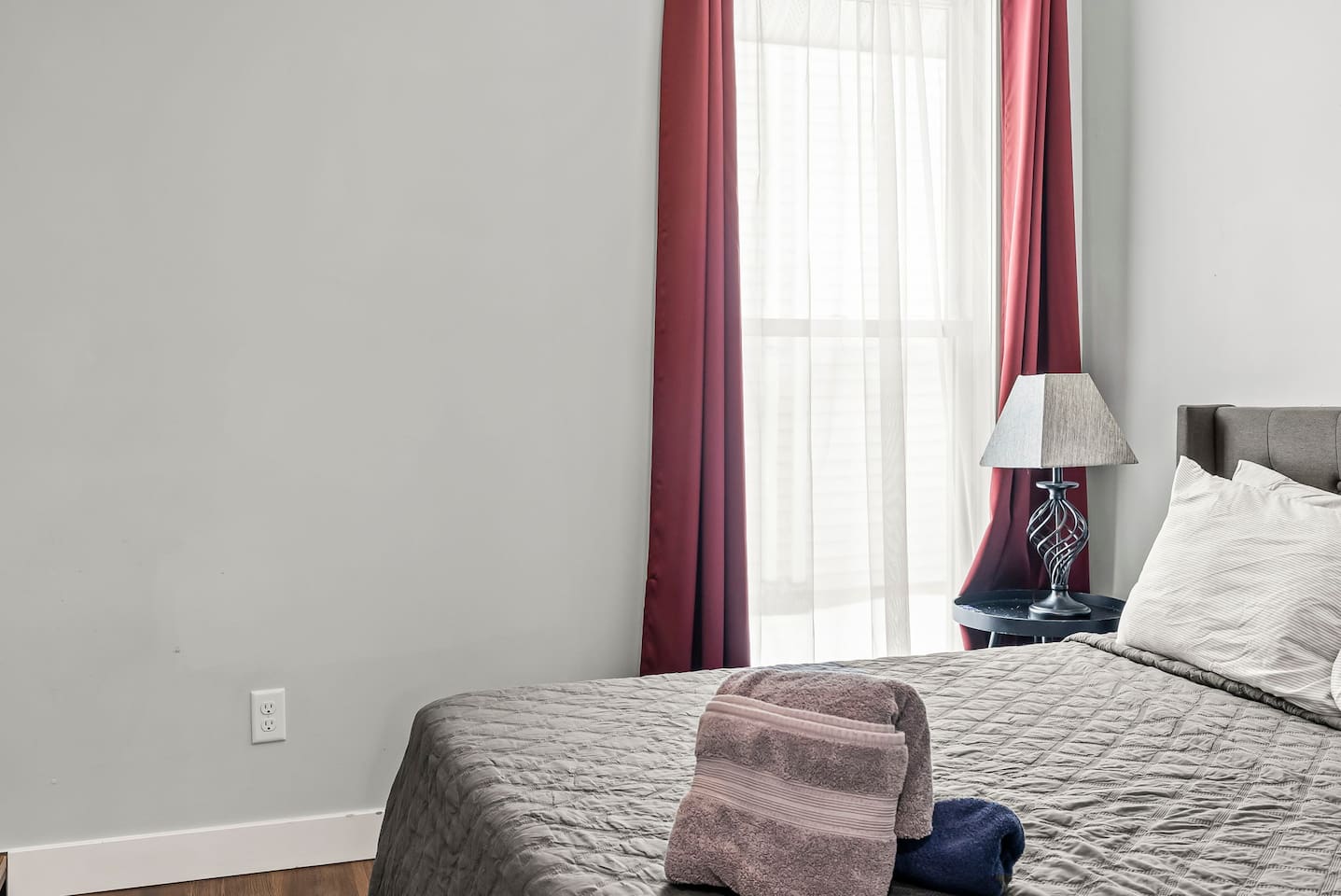 Detailed bed view highlighting plush pillows, quilted bedding, and a calm, neutral design.