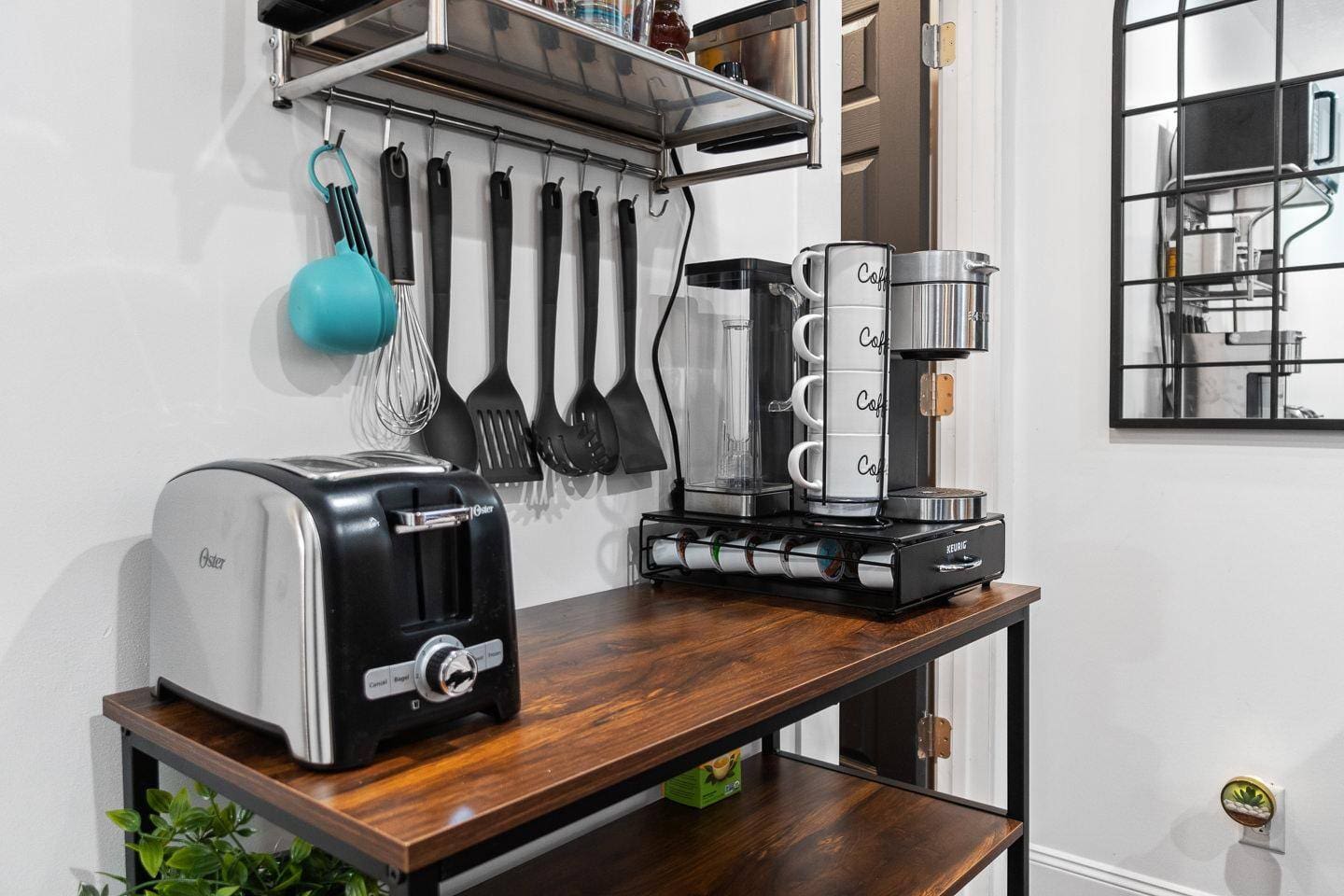 A cozy coffee bar setup complete with a coffee maker, a selection of mugs, and a variety of coffee options to start your day right. Perfect for brewing your favorite cup in a warm and inviting space!