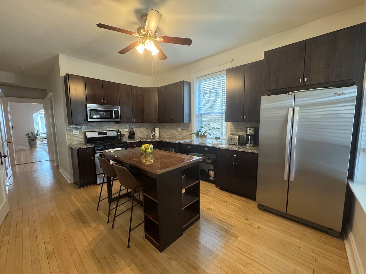 Large modern kitchen with stainless appliances and spacious island.