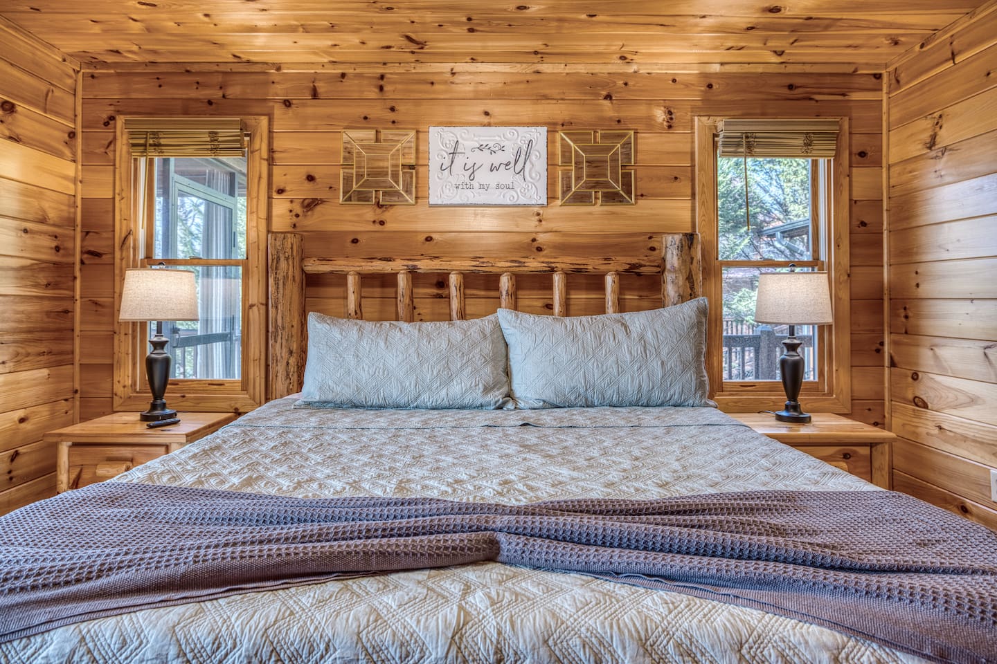 Main-level master bedroom includes a king bed, a private full bathroom, and mountain views! The screened-in patio is right off the master bedroom. 