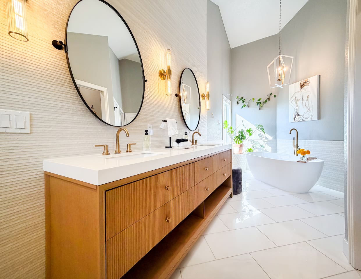 Indulge in a spa-like retreat in the luxurious master bathroom, featuring a custom double vanity and a standalone tub designed for ultimate relaxation and privacy.”