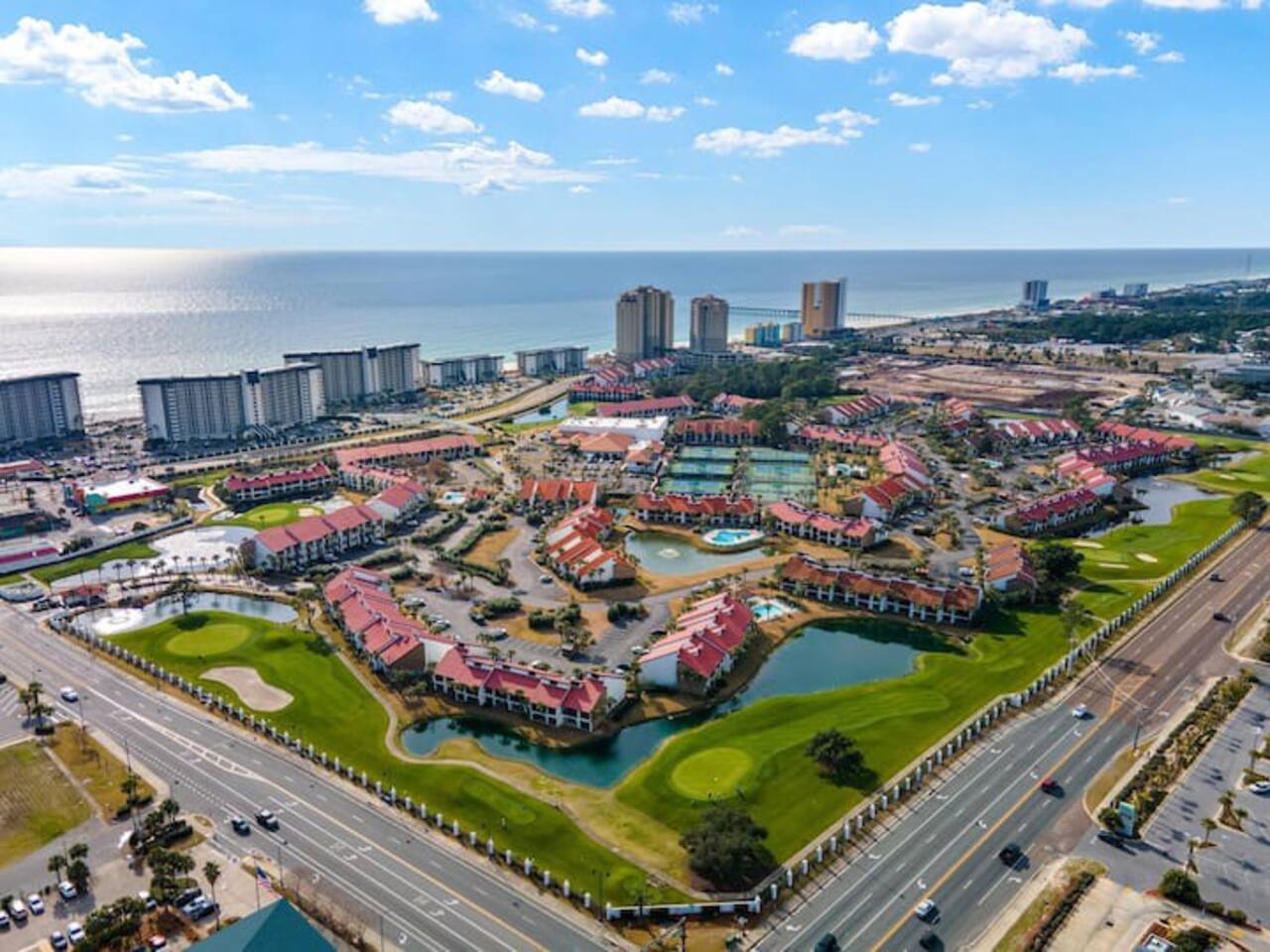 Aerial shot of the Edgewater Beach and Golf Resort. Beach towers on the left closer to the ocean, Golf Villas on the right with the red roofs.