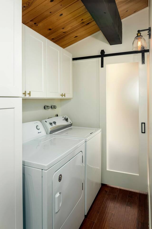 Full-size laundry.  Detergent provided (above), sliding barn door to main level half-bath.