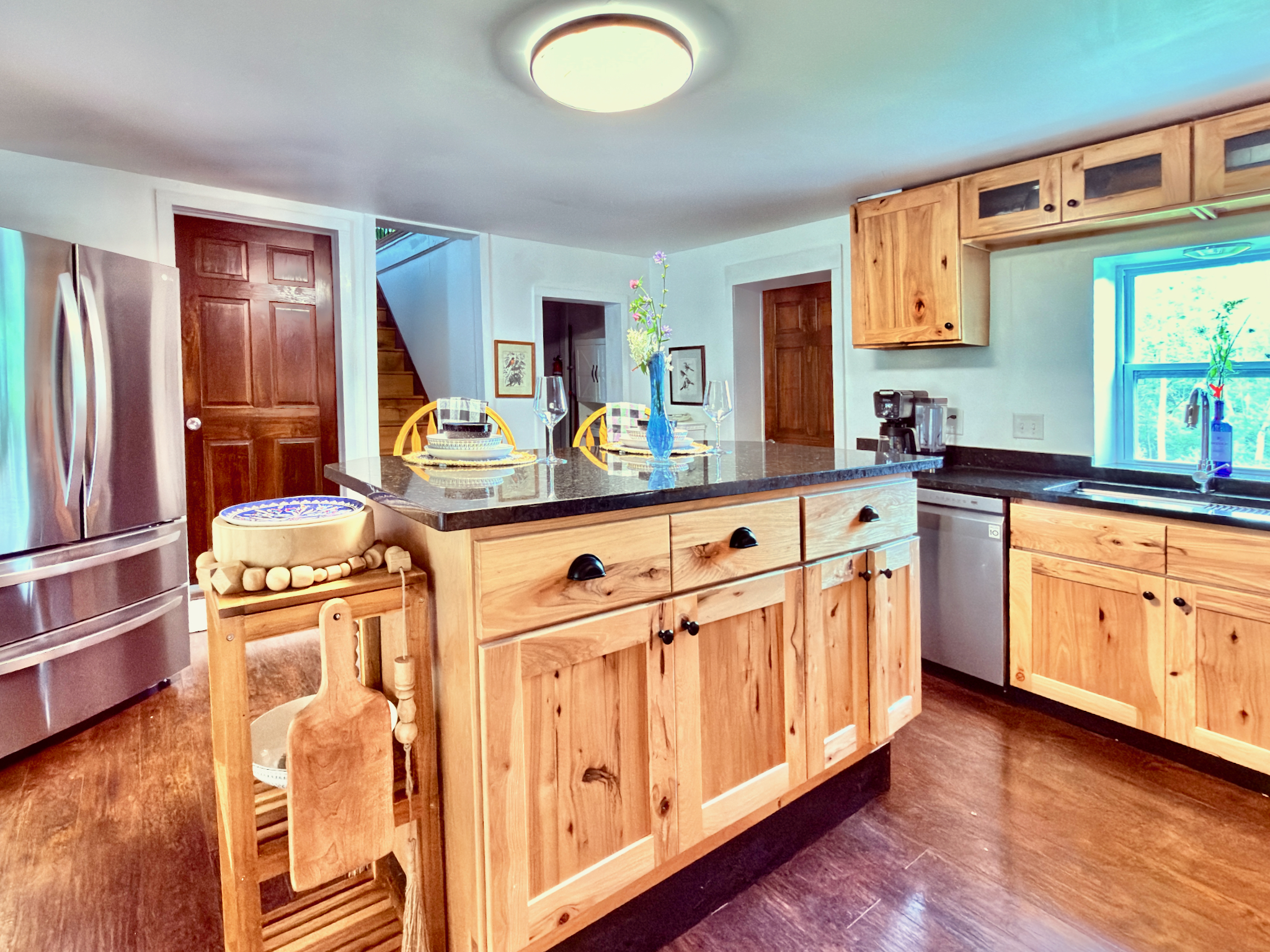 Fully equipped kitchen featuring granite counters, a spacious island, and premium LG appliances. A bright, functional space perfect for preparing meals during your stay.
