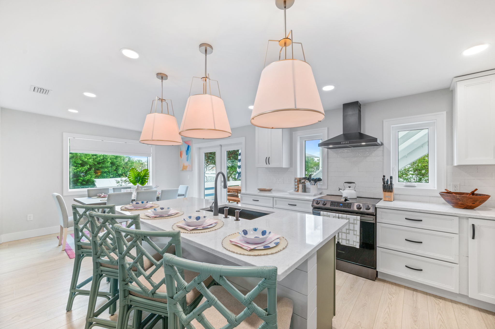 Cook and gather in style with our newly renovated open-concept kitchen! Featuring chic pendant lights, a charming green island, and a fully stocked setup, it’s perfect for family meals and entertaining. 🍽️✨ #KitchenGoals #GatherAndEnjoy