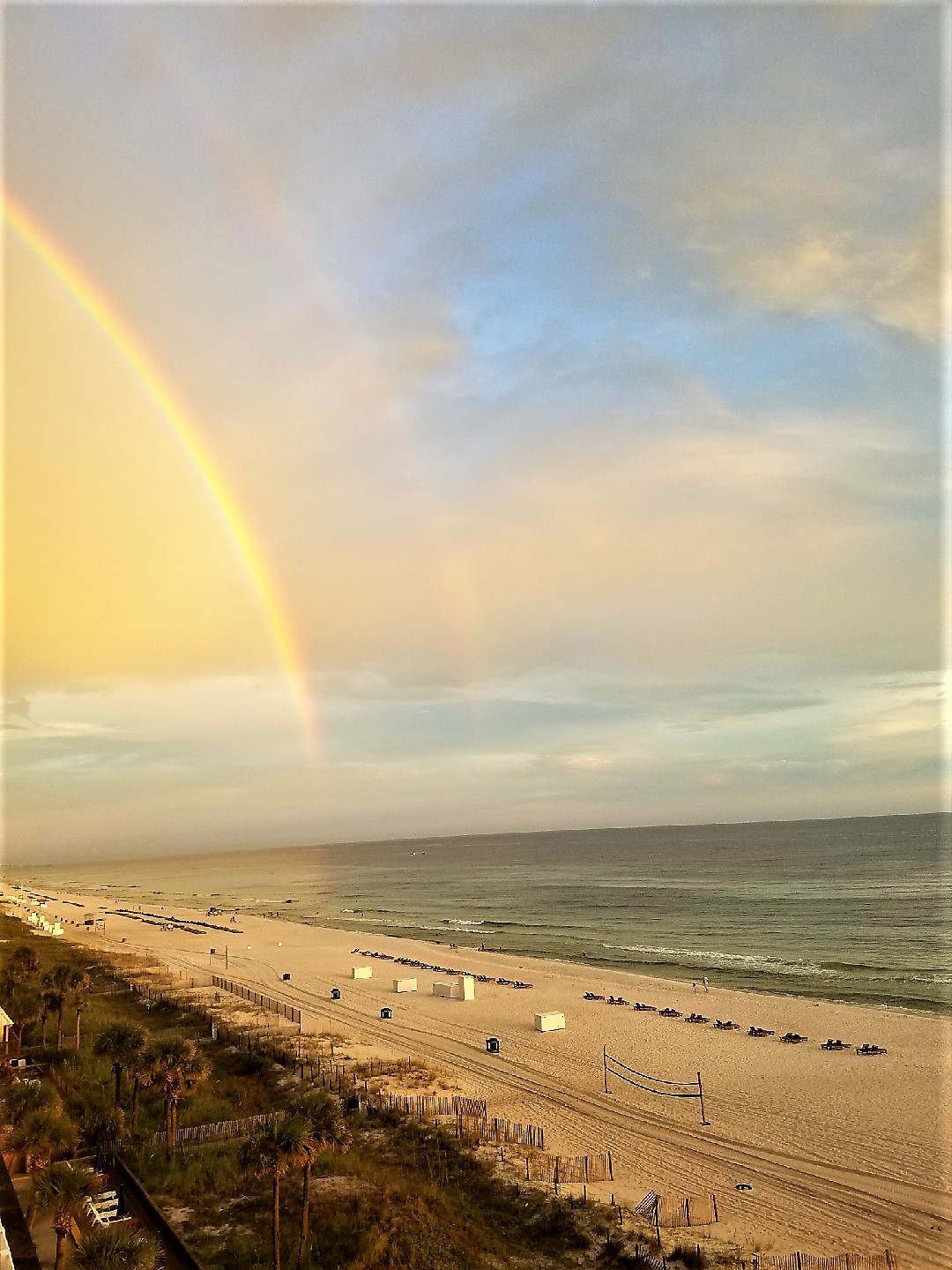 View to the east of a rainbow from the private balcony at sunset