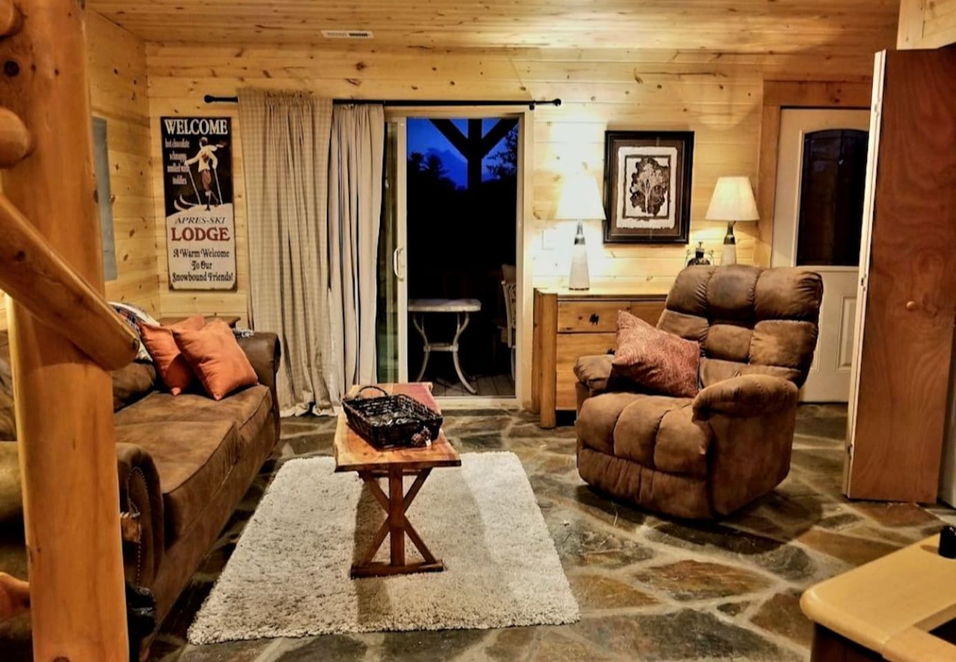 Lower-Level  living room/ game area with large flat screen tv, foos ball table/games- doors to lower , fully enclosed deck with seating and exit gate - with mountain/river views!
