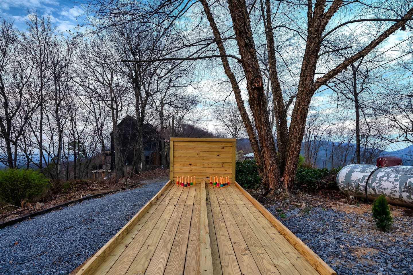 An inviting outdoor bowling lanes with scenic mountain backdrop and vibrant sunset for unforgettable game nights.