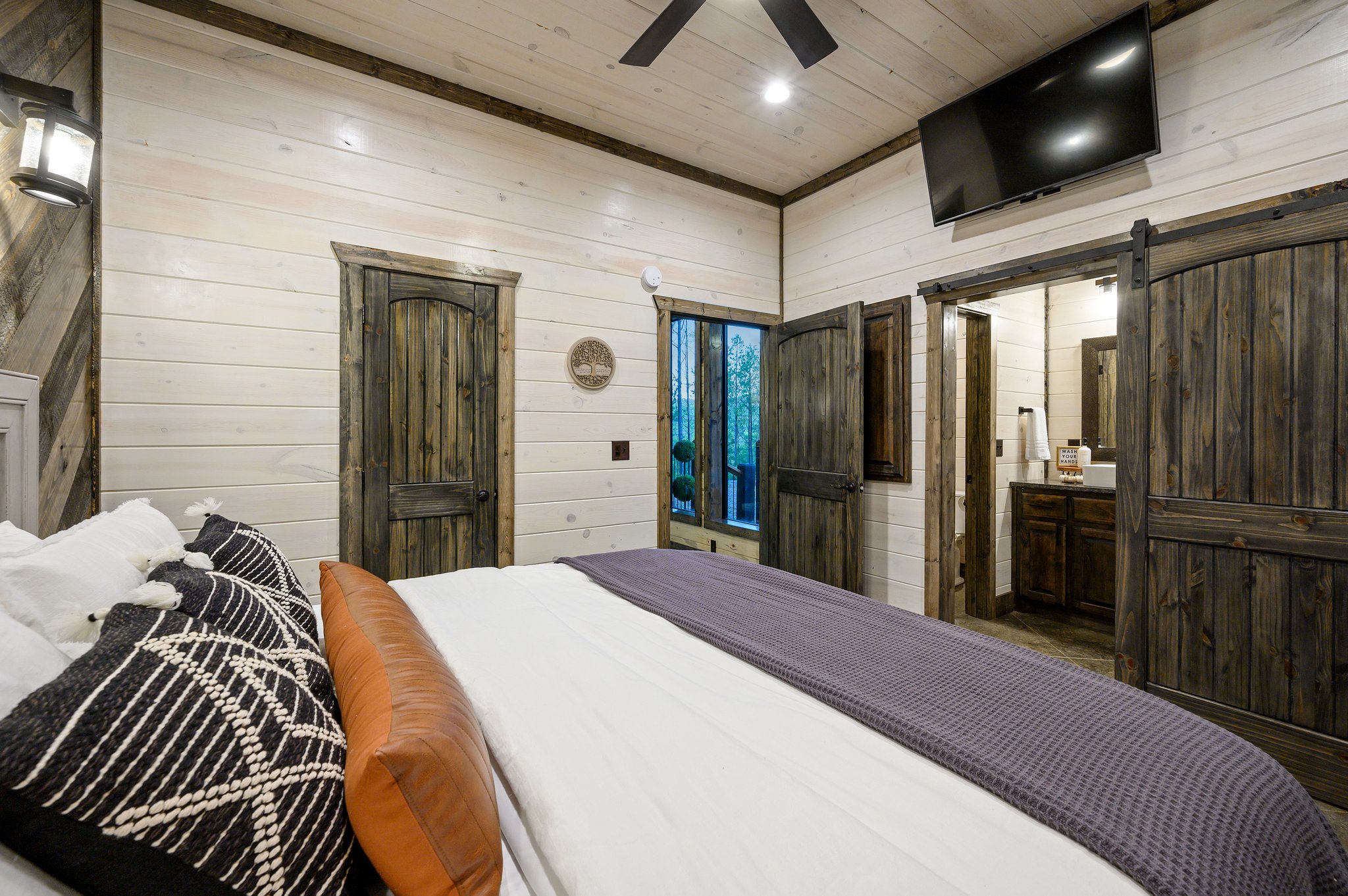 Cozy up in style with chic barn-door accents and warm ambient lighting.