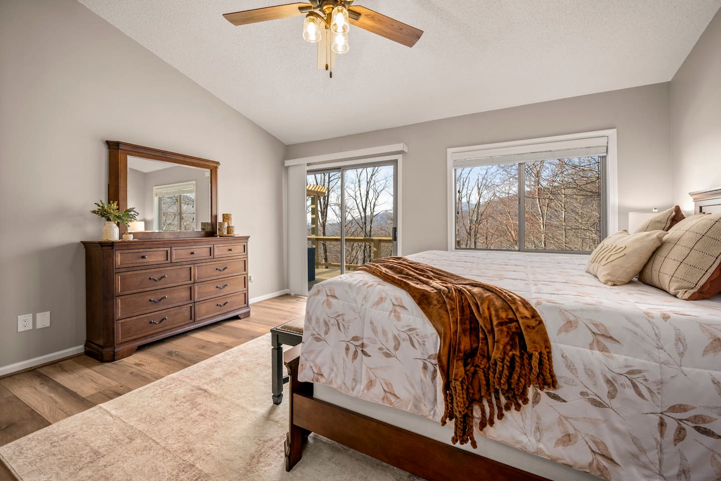Bedroom #1 on main level of home with en suite bathroom and deck access 