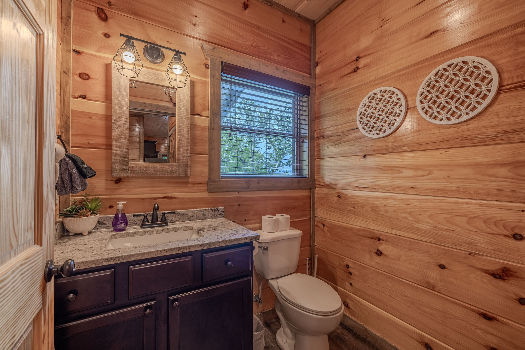 A convenient main-level powder room is located near the living, dining, and kitchen spaces.