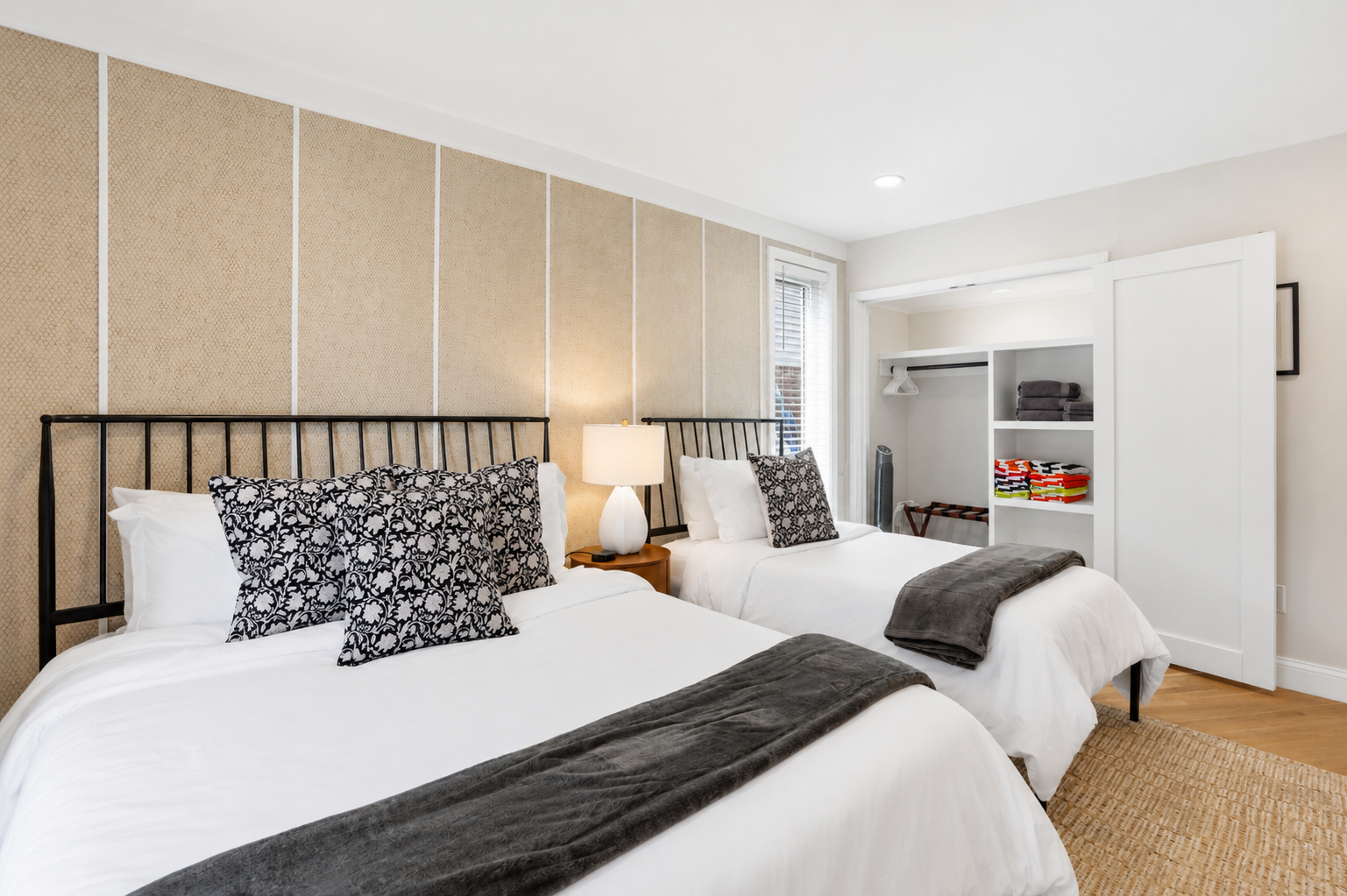Bright, airy bedroom with plush bedding, modern décor, and serene views—perfect for a relaxing stay.
