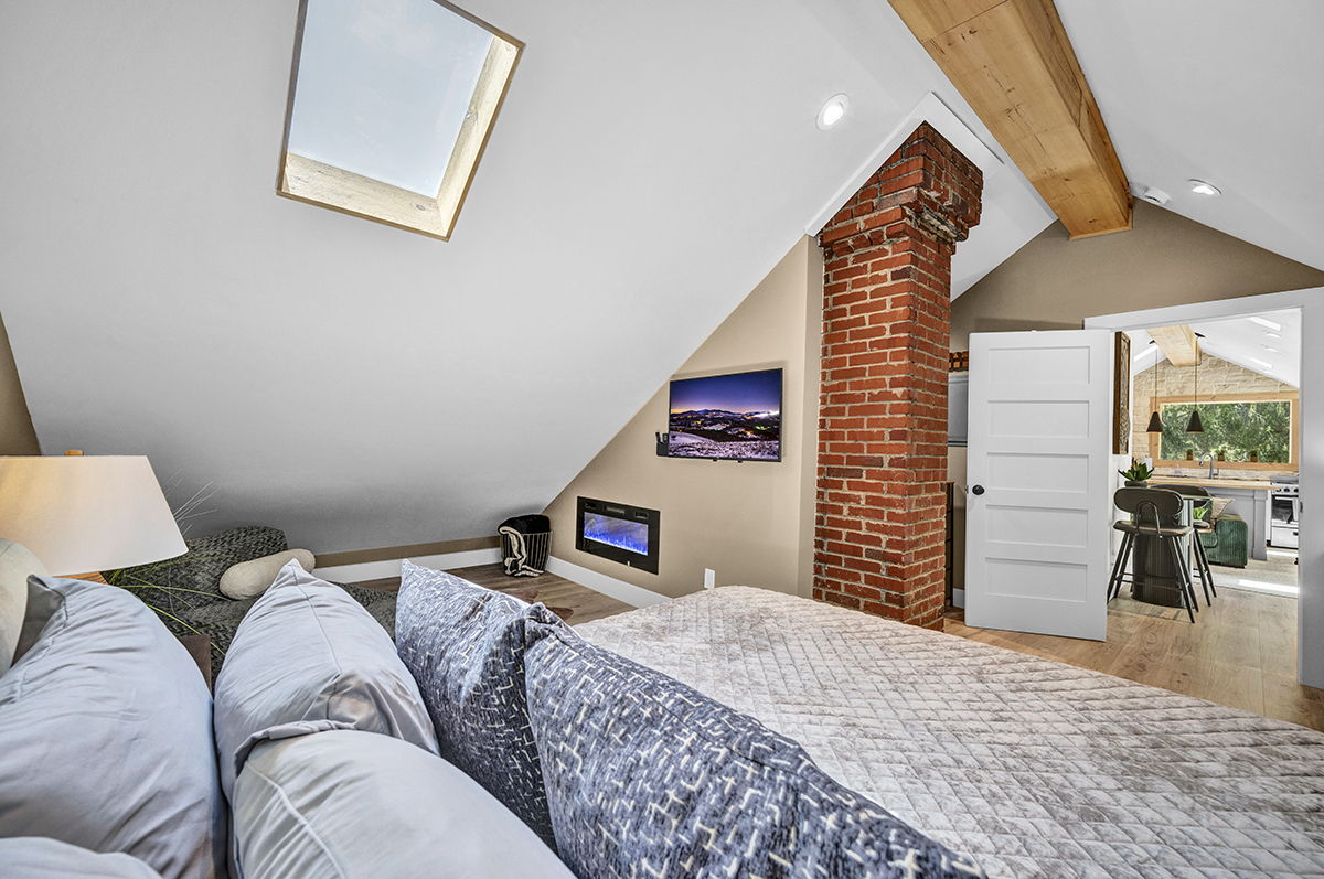 Master Bedroom with King Bed, 42-inch Smart TV, Fireplace, sound machine, blackout curtains and cozy reading chair