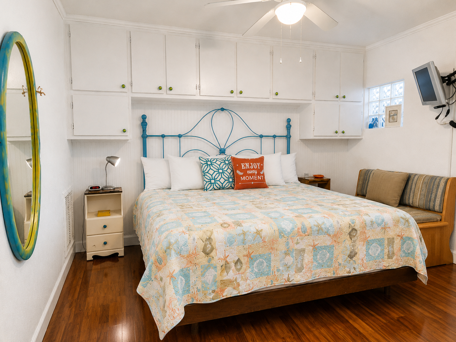 From the doorway into the bedroom - Huge king bed,  lots of storage, wall-mounted TV.  (Bathroom located to the left before the bedroom doorway.)