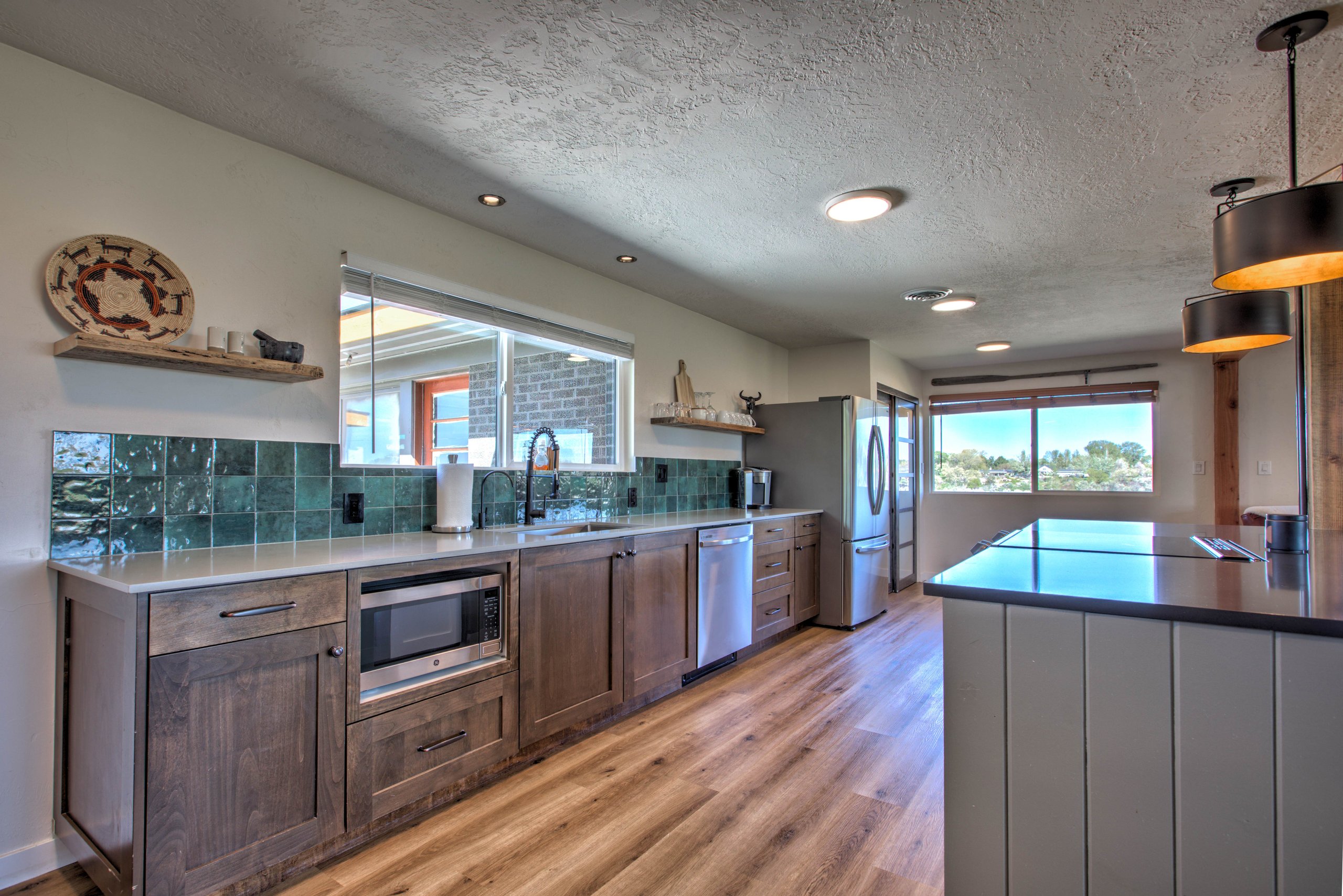 Kitchen and dining opening onto the bright living space