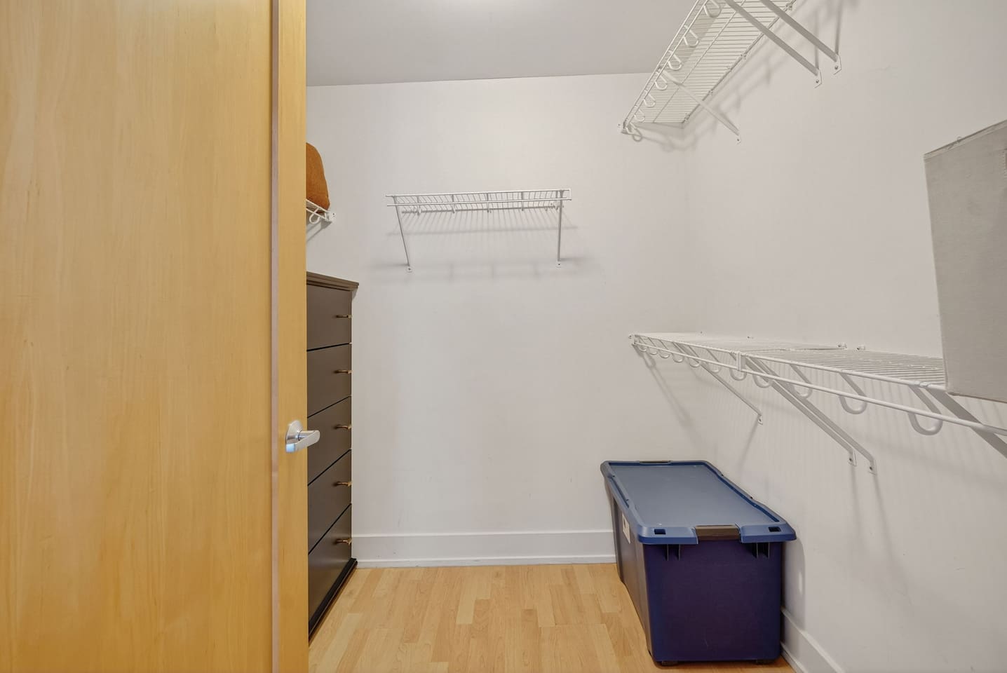 Stay organized with a spacious walk-in closet featuring ample shelving and storage. Perfect for extended stays, this thoughtful amenity adds convenience and comfort to your downtown Des Moines retreat.
