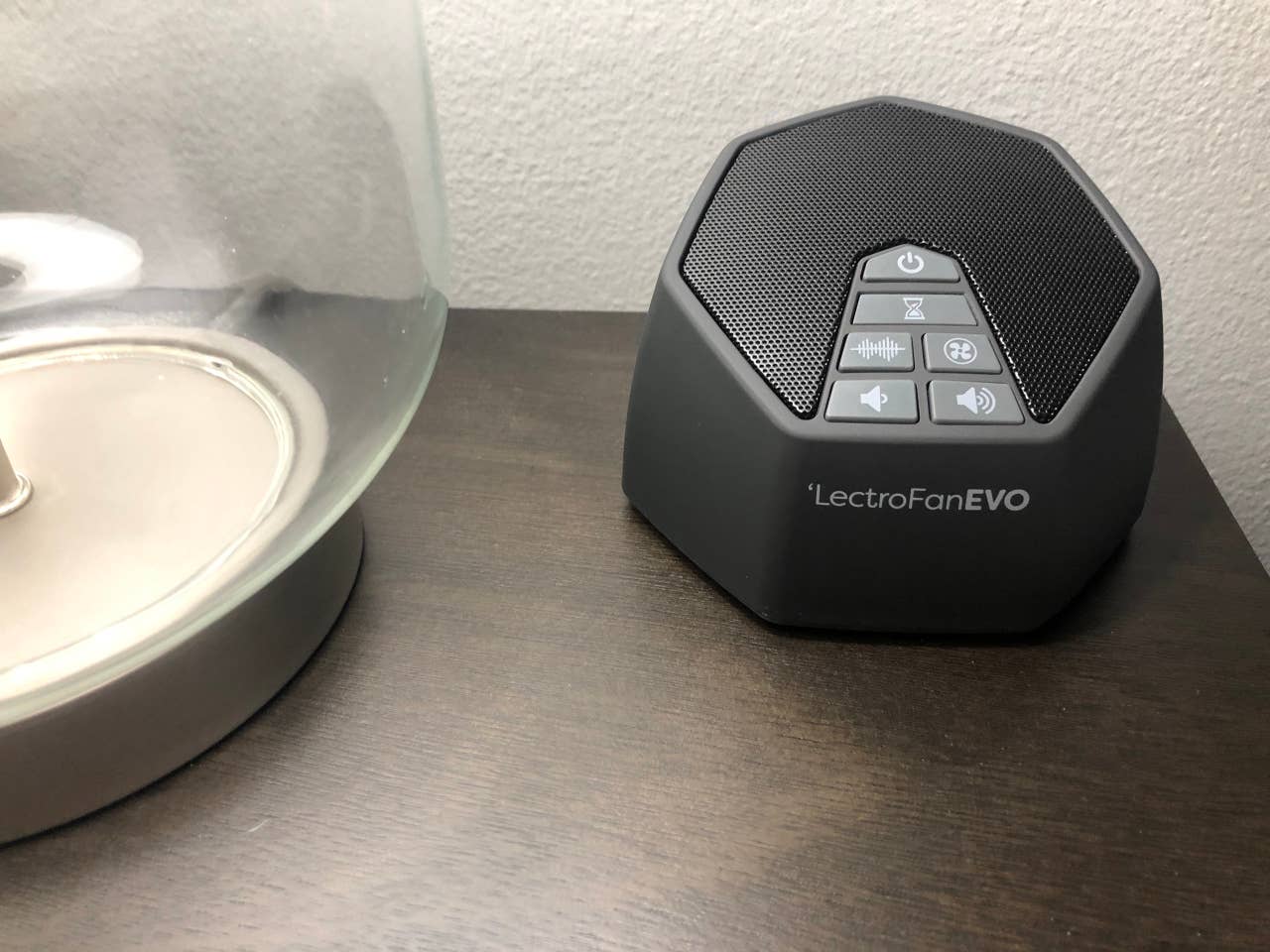 White noise machine for light sleepers and multi plug USB charger on bedroom night stand