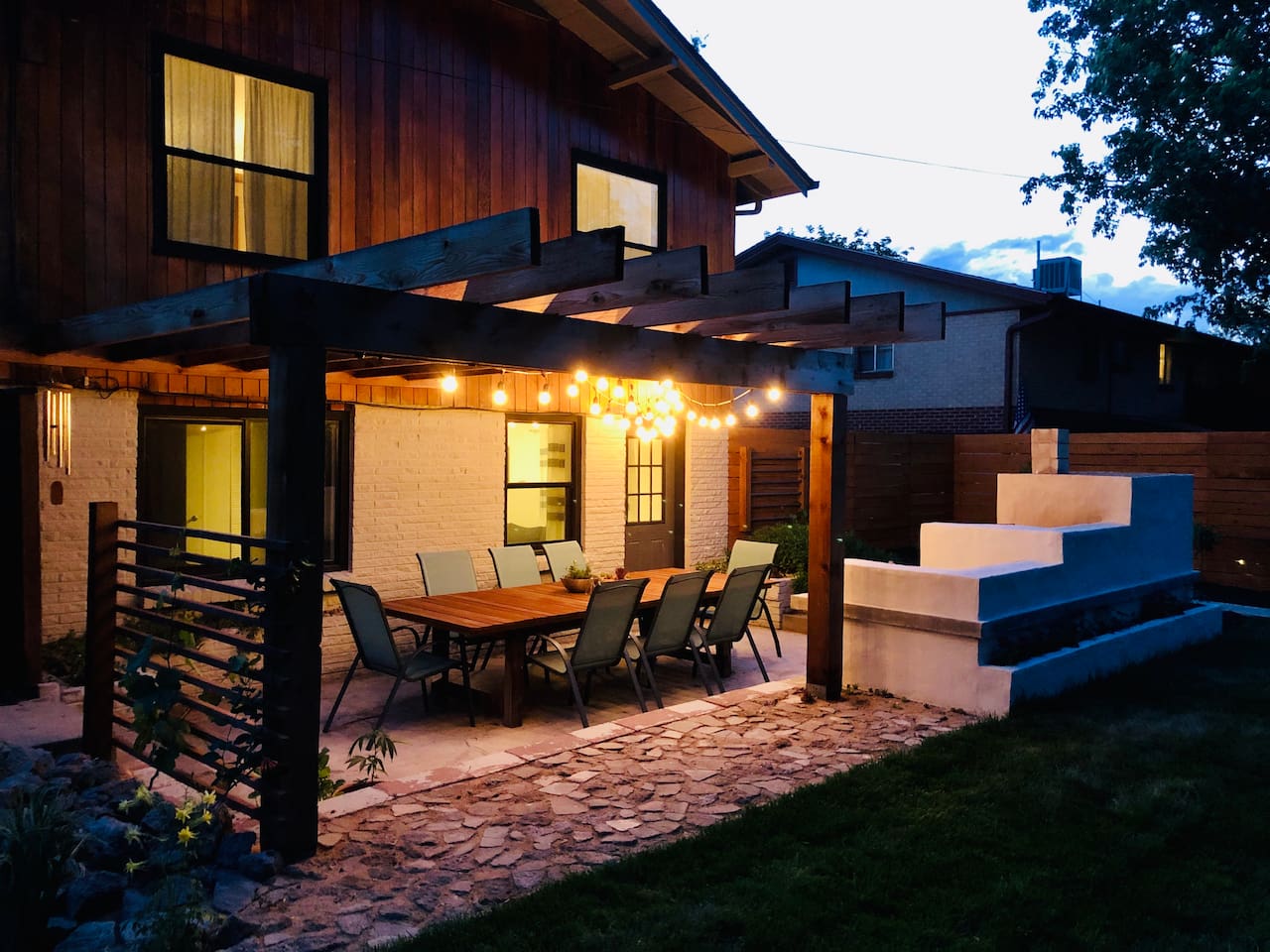 Outdoor patio with custom-built kitchen and seating for eight