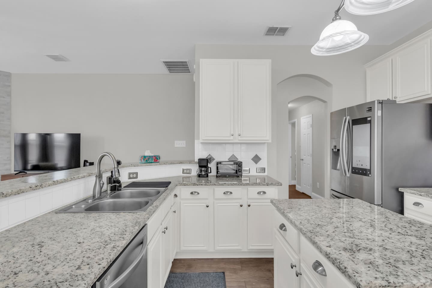 Stocked with cookware, pots, pans, dishes, silverware, and essential kitchen tools to support short and extended stays.