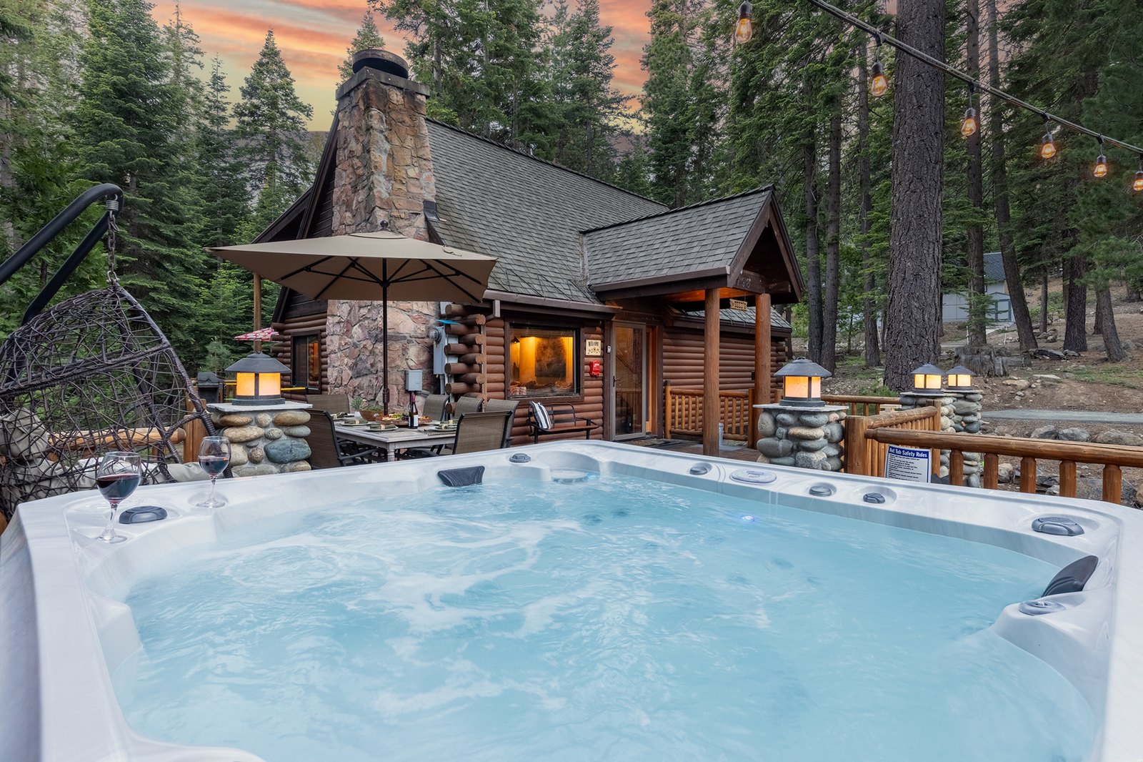 Sink into the bubbles after a day on the slopes or the trail — warm water, cool pines, and the cabin lit up behind you.