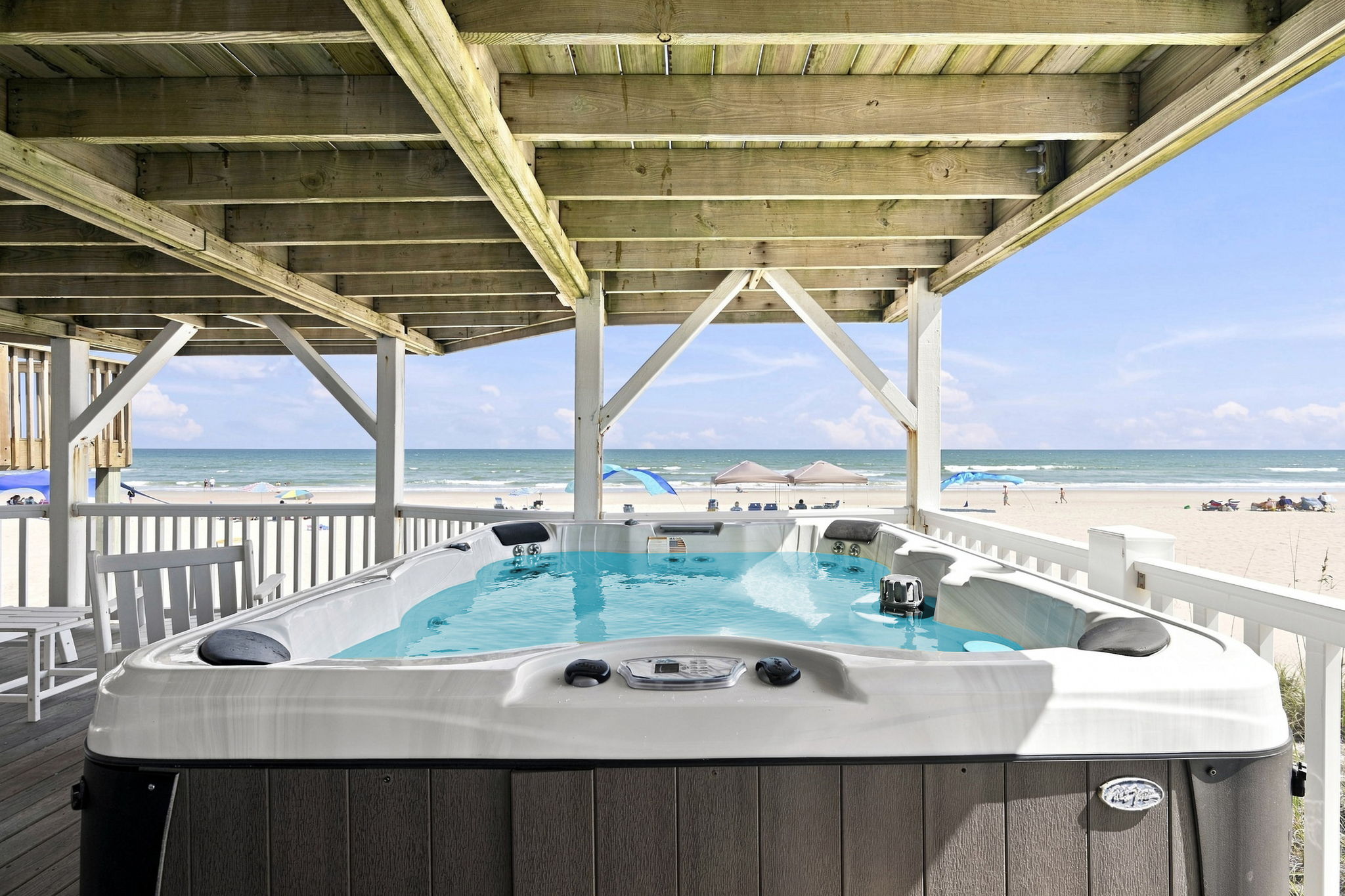 Soak your cares away in the sparkling blue hot tub while enjoying the ocean breeze.
