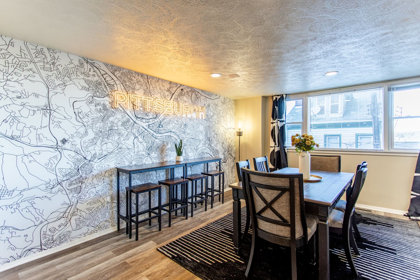 A stylish 6-seater dining table set against a backdrop of neutral tones, featuring modern chairs and a simple centerpiece for an intimate dining experience.
