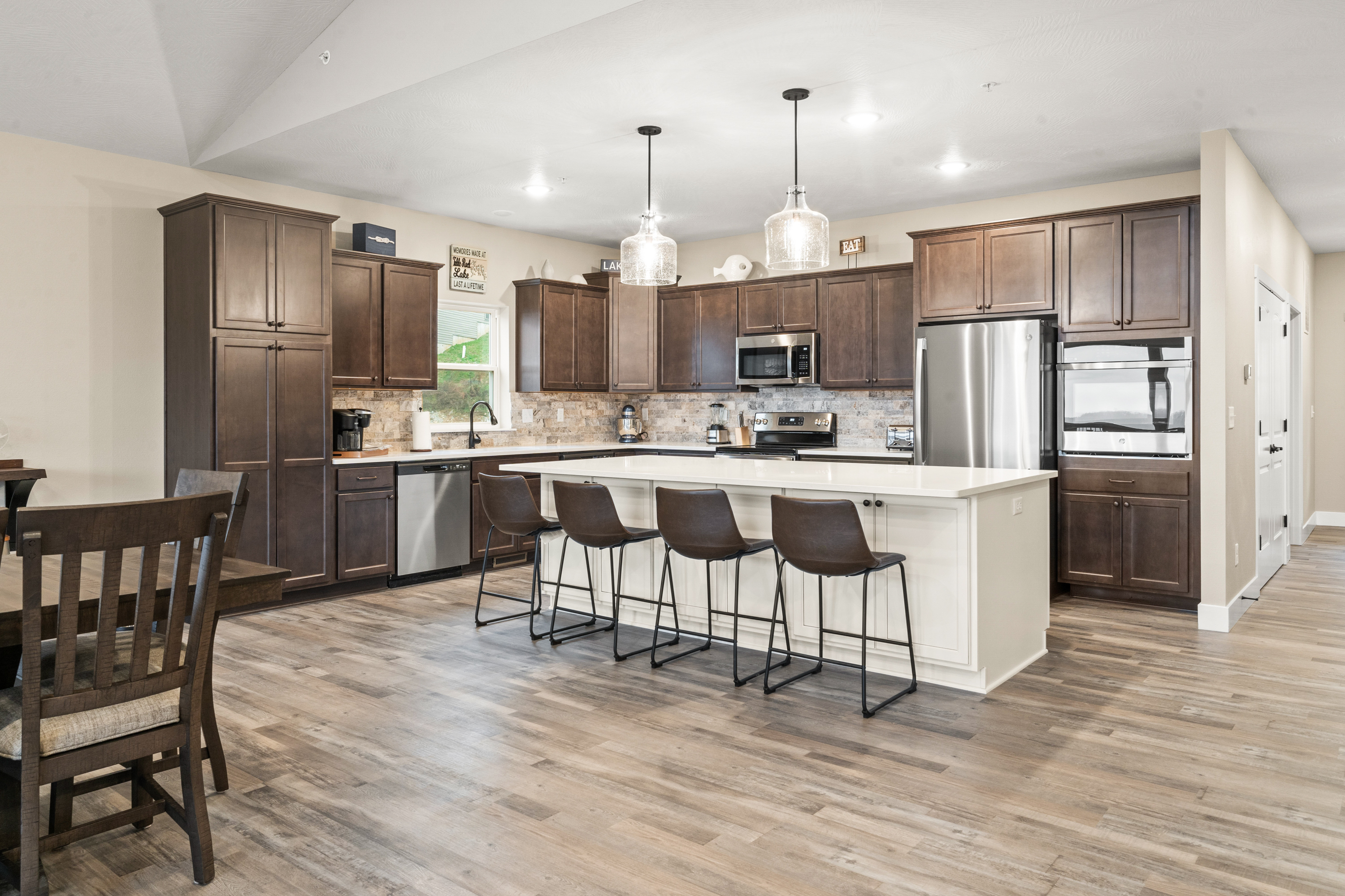 Fully stocked Kitchen has (2) dishwashers, (1) microwave, slide in range with oven, (1) wall oven, large refrigerator/freezer with ice maker. The island seats four.