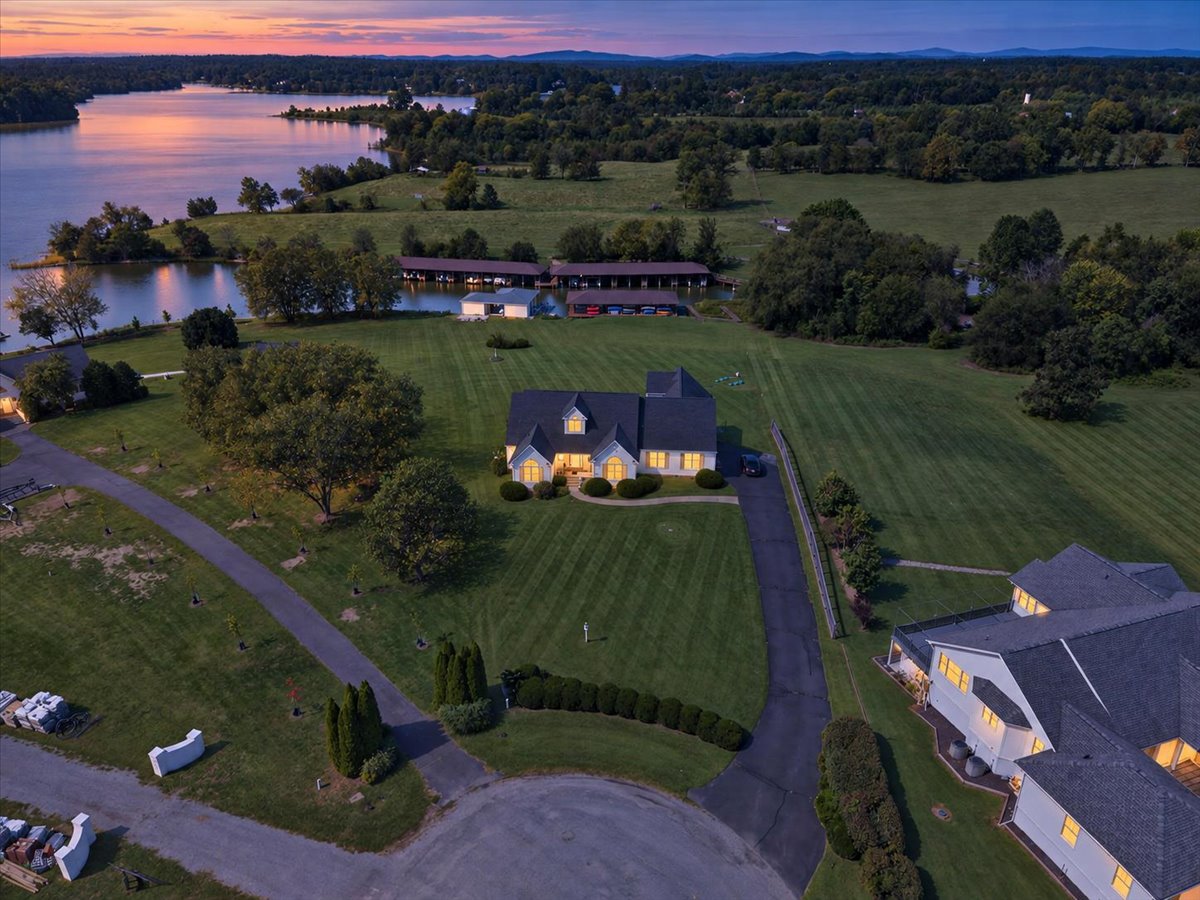 Aerial view showcasing the home’s spacious lot, waterfront setting, and private boathouse.