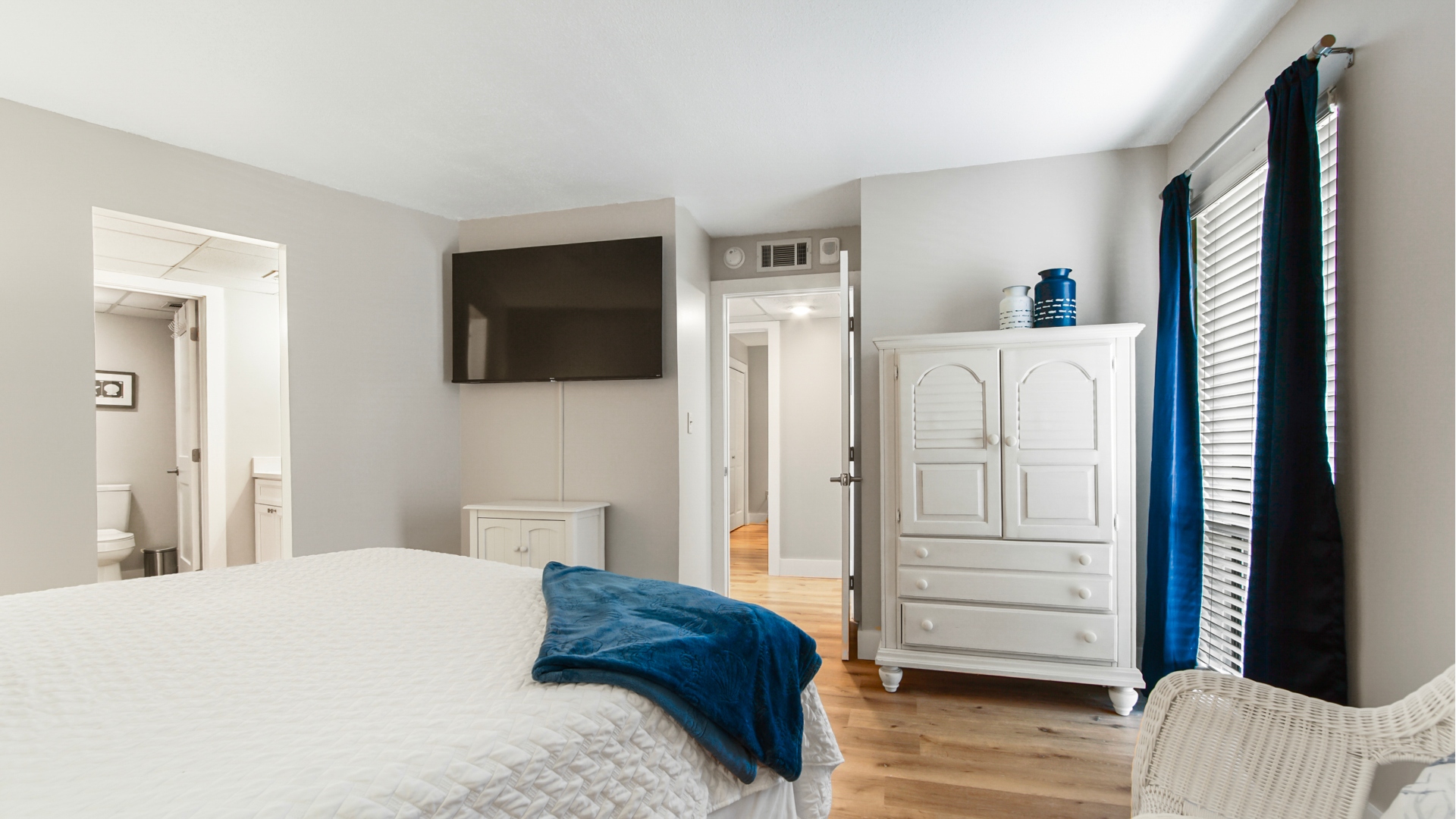 Main bedroom with king bed, ensuite bathroom, smart TV and clothing storage