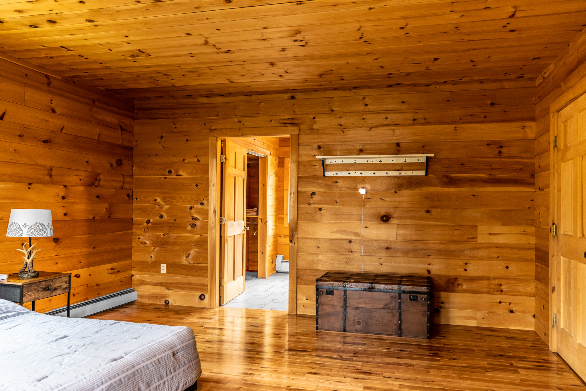 Enjoy another full suite upstairs with a full and 2 twin beds, full bathroom with large closets, charging station by your bed, TV for streaming, and all with lake views.