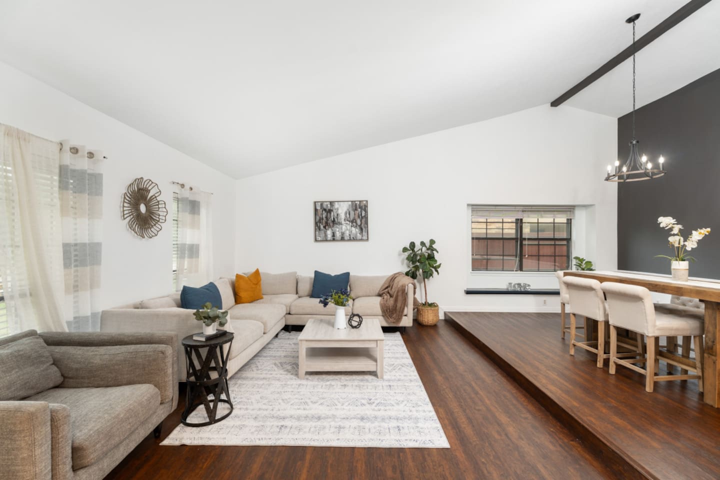 Modern living space with open floor plan to the kitchen.