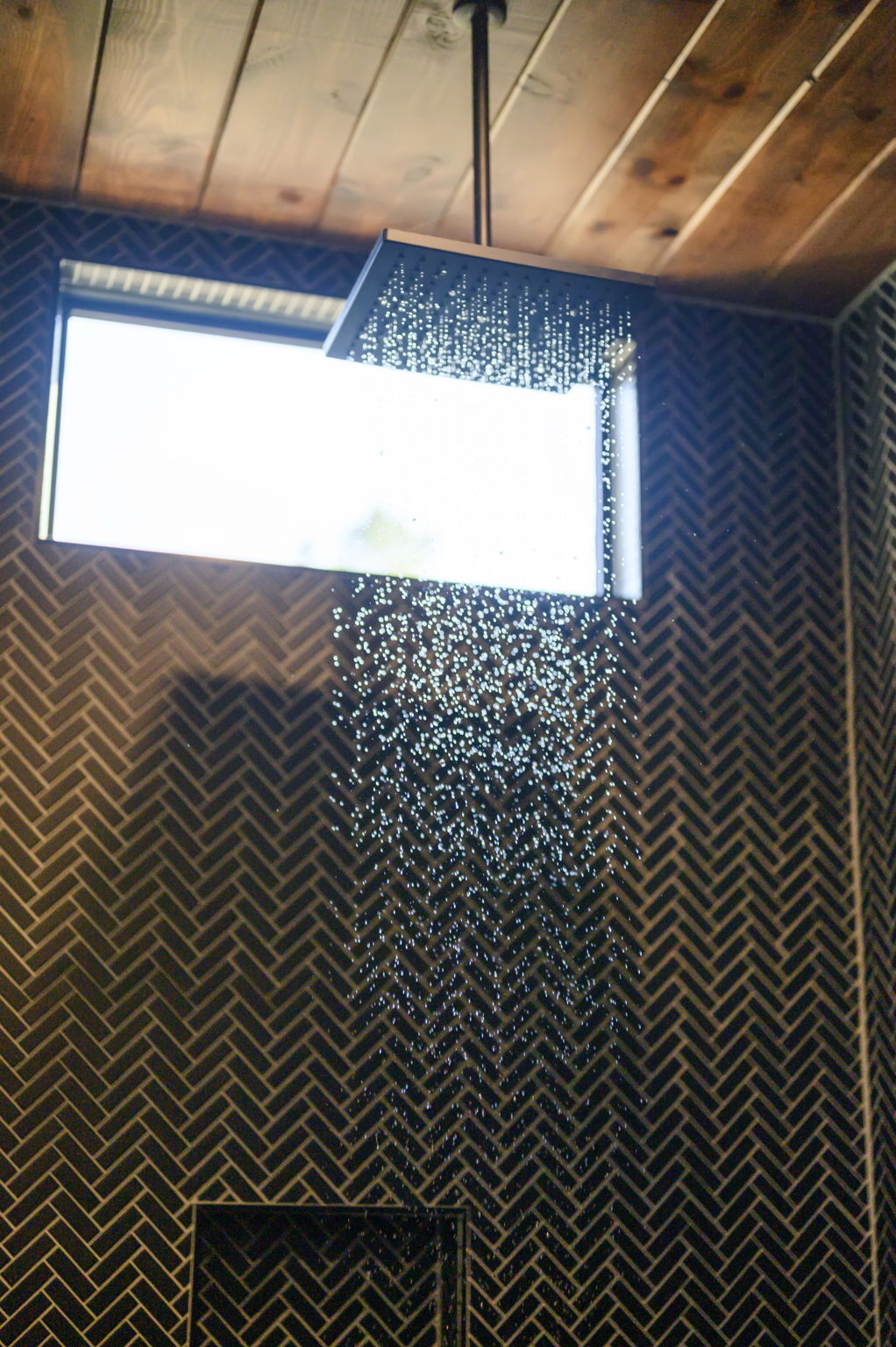 Semi-private bathroom for those staying in the Bunk room. This bathroom features modern teak finishes, stunning modern design, and an oversized rain shower with dual shower heads. 
